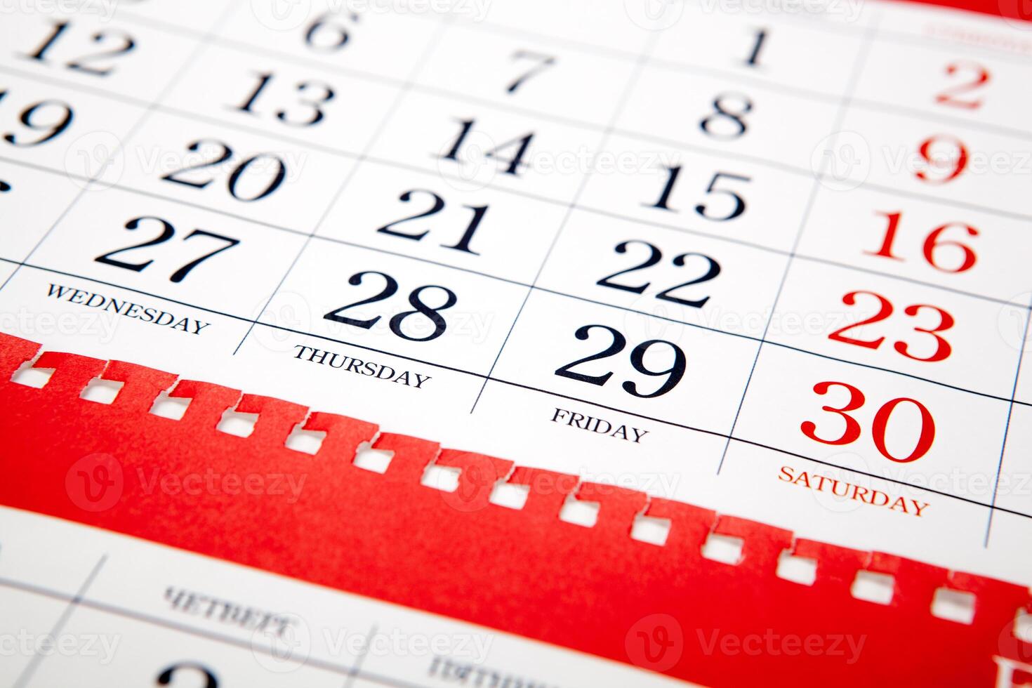big pile of red wall calendar sheets closeup photo
