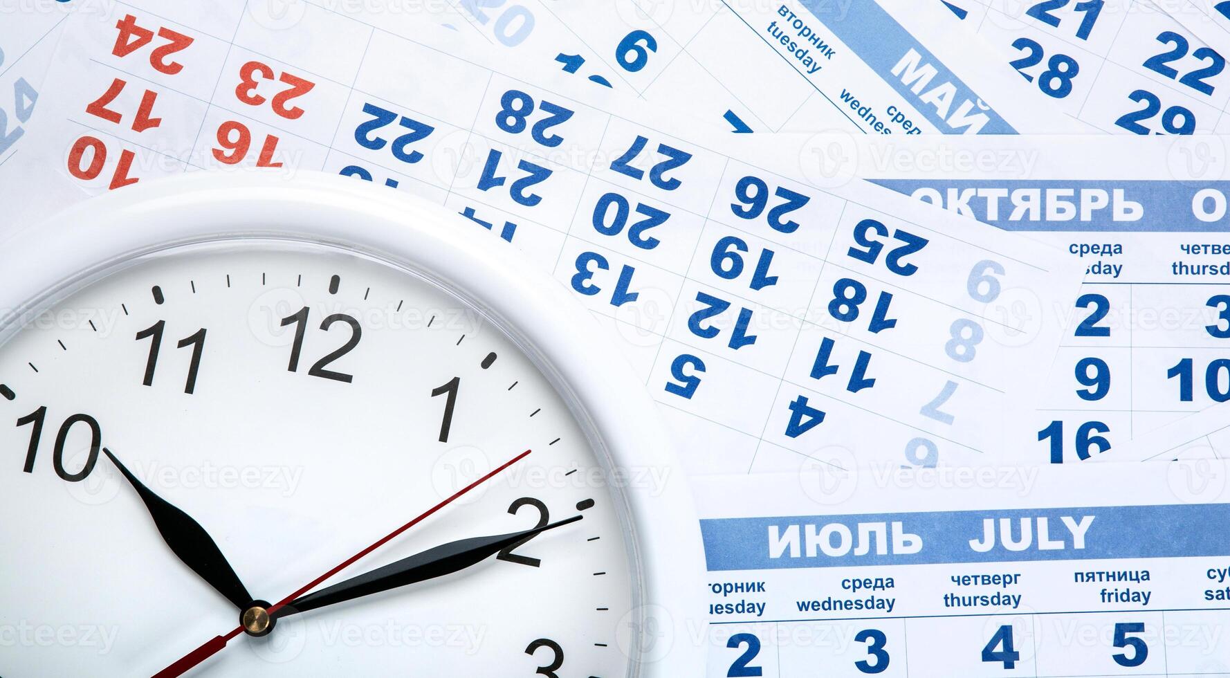 clock with wall calendar sheets with the number of days photo