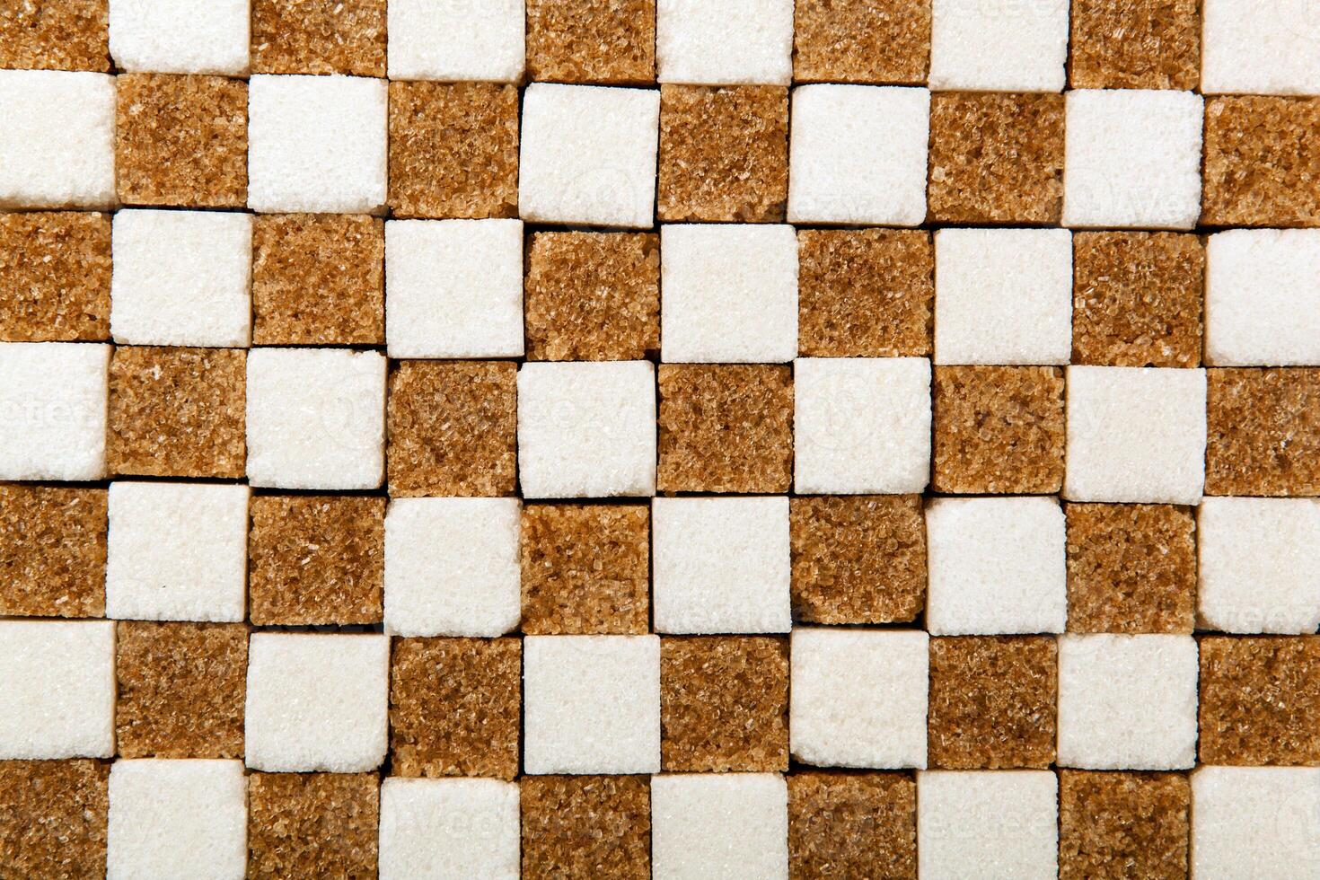 background of cubes of brown and white sugar photo