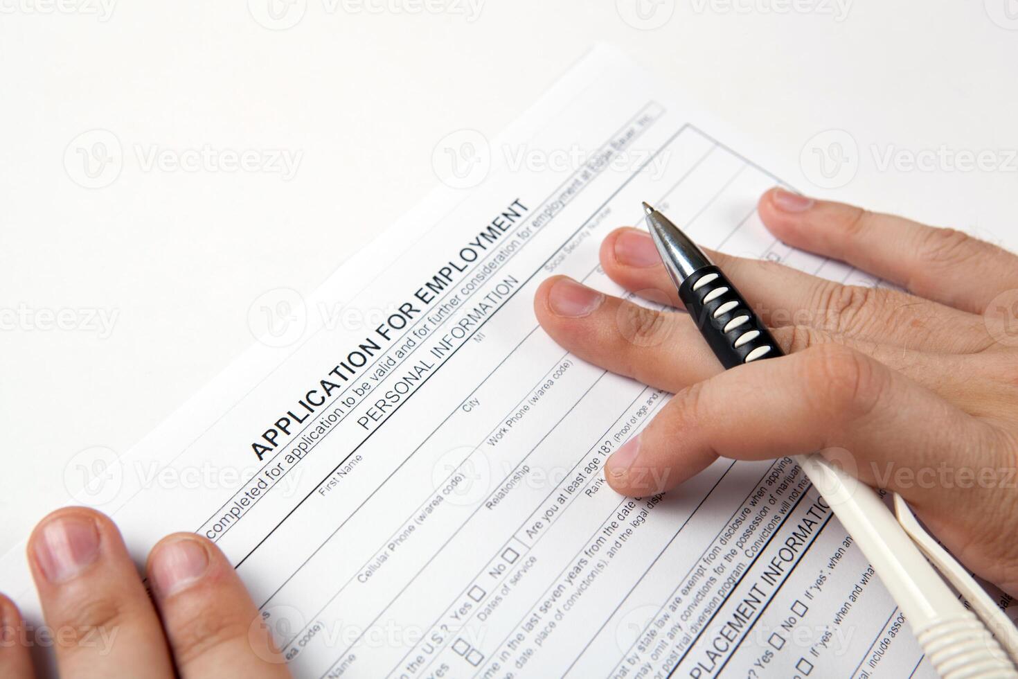 human hand and the form of the document application for employment photo