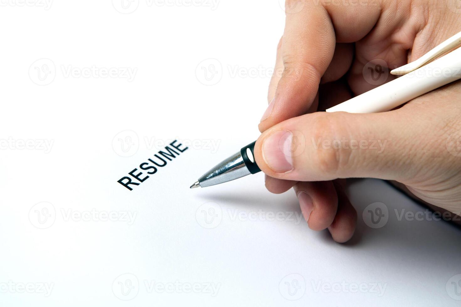 Man's hand on resume form and pen photo