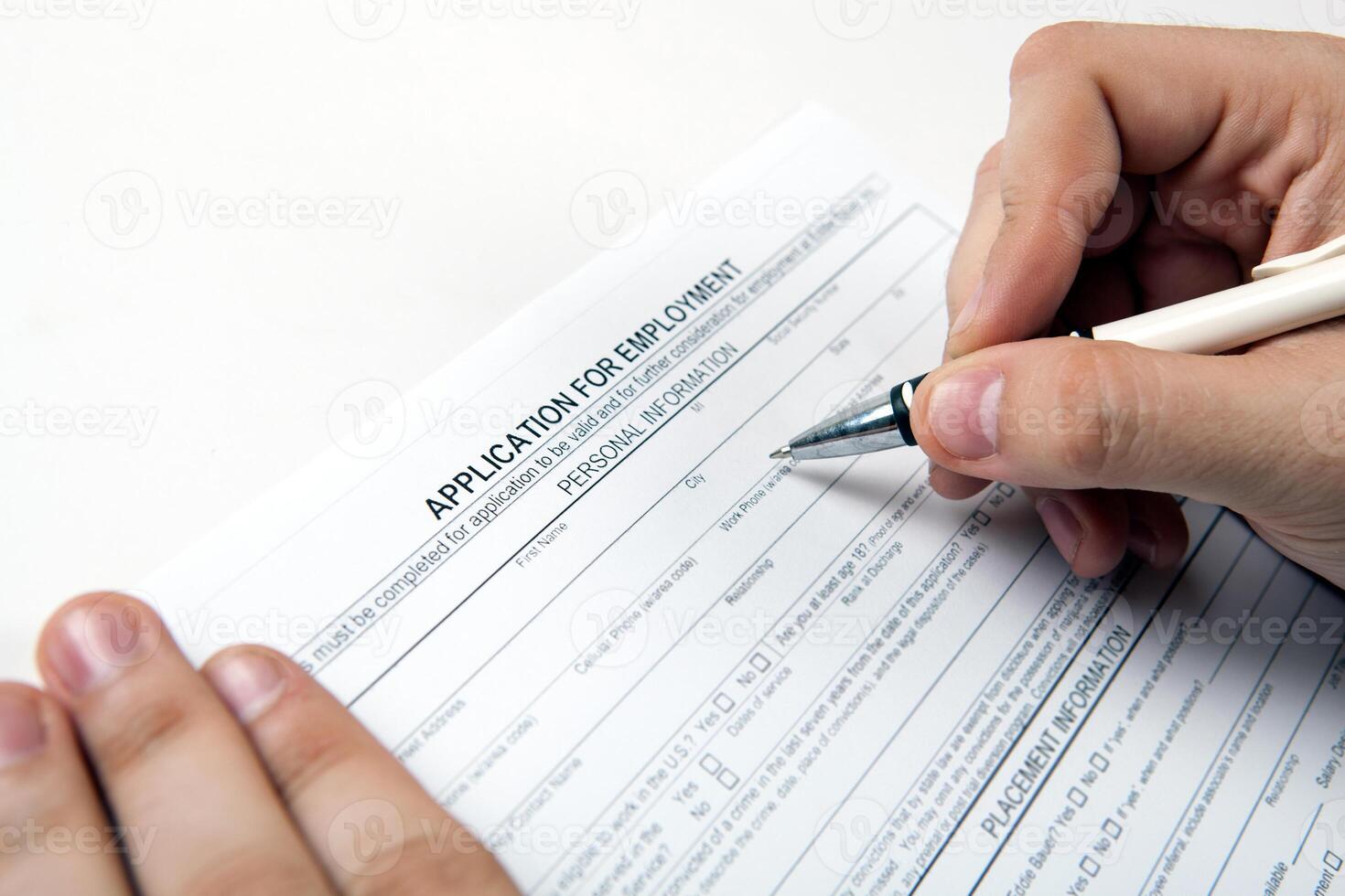 human hand and the form of the document application for employment photo