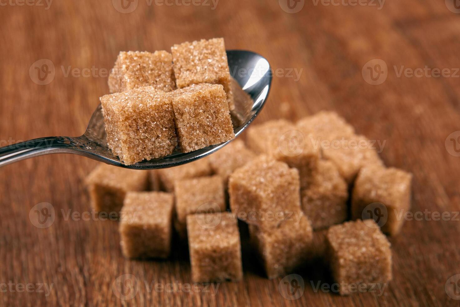 tablespoon with cubes of brown sugar photo