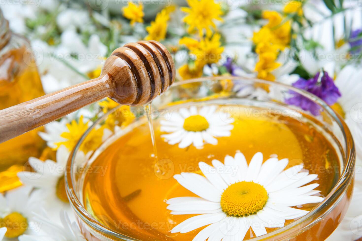 Still life of fresh honey and flowers photo