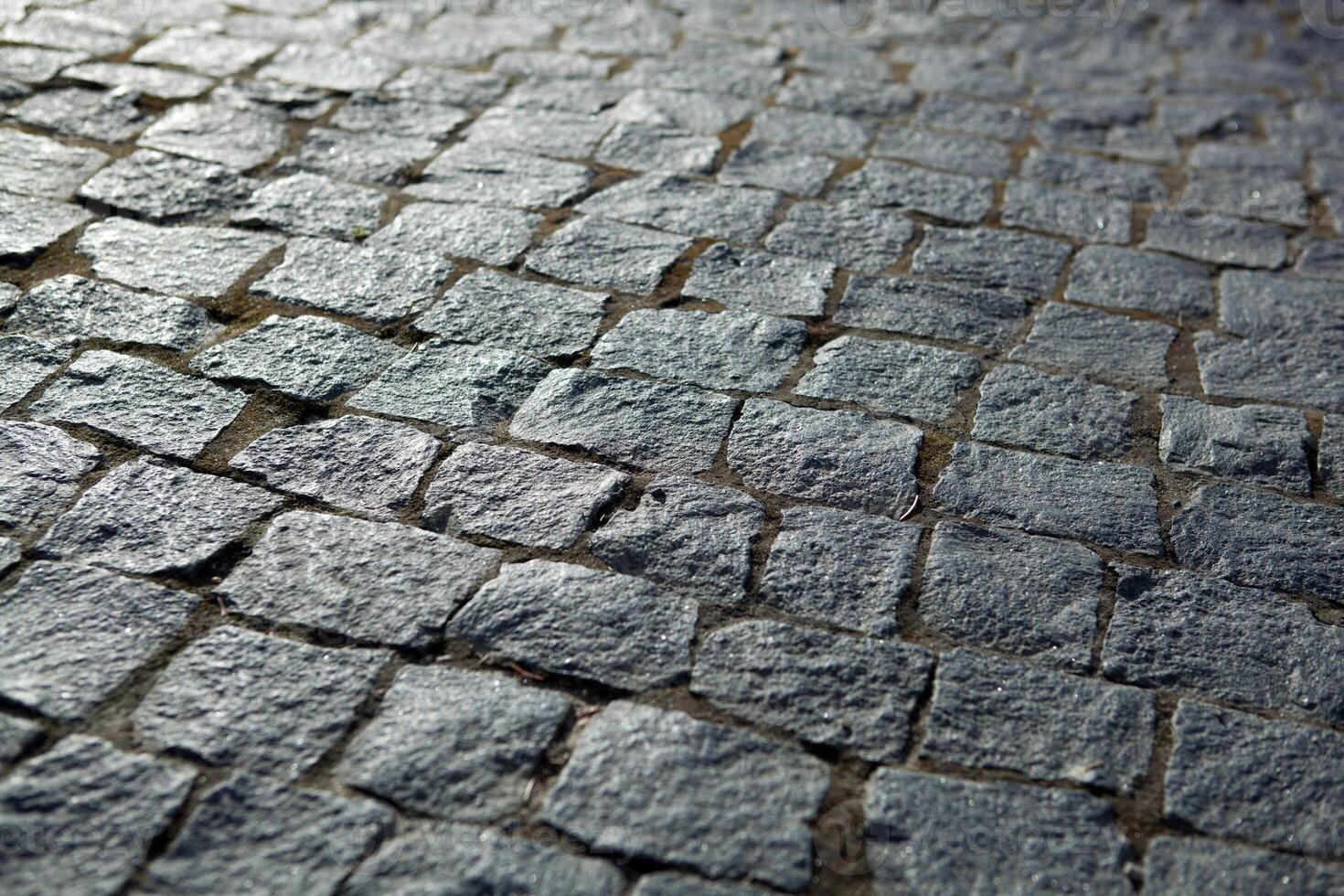 Abstract background of old cobblestone pavement photo