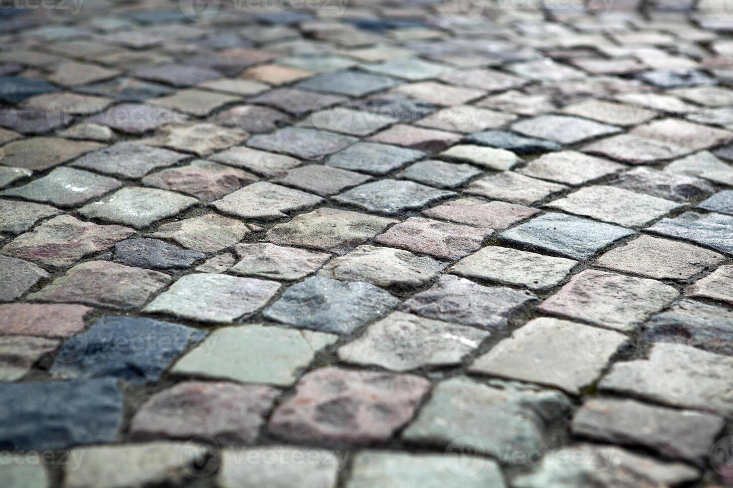 Abstract background of old cobblestone pavement photo