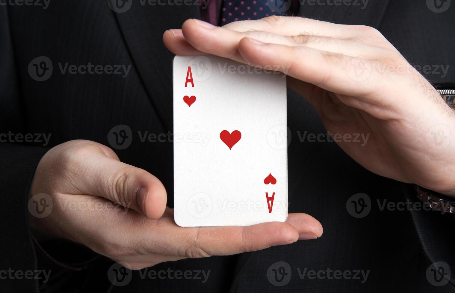 man holding a deck of cards and the ace of hearts photo