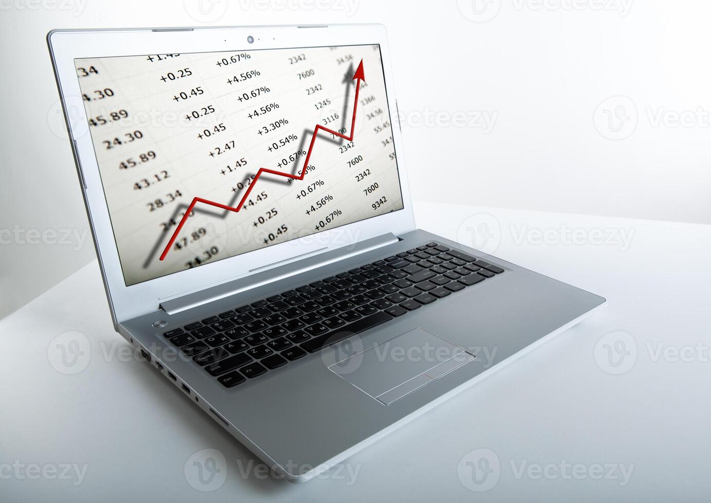 working at a laptop analytics forecasting calculations photo