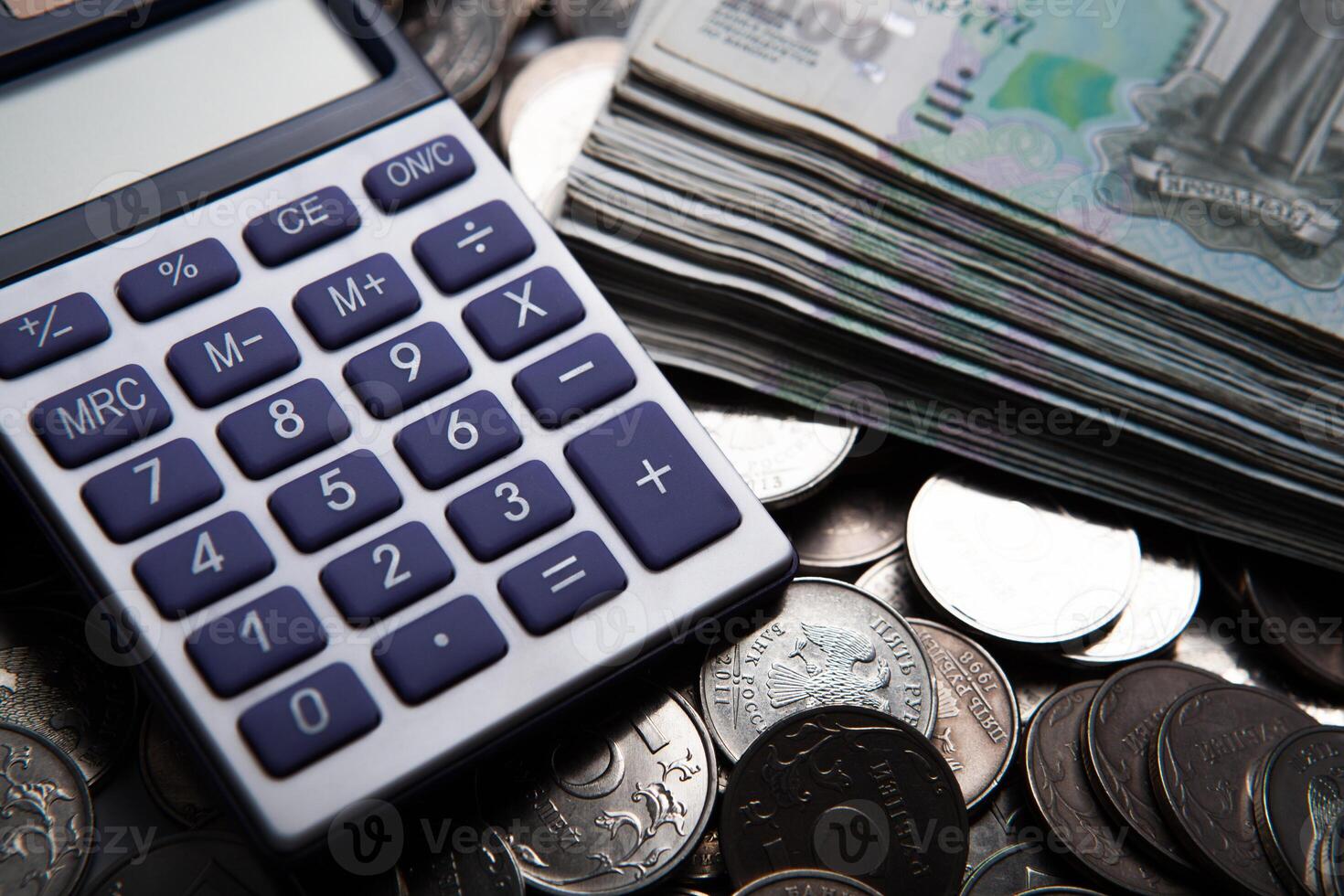 money in the form of banknotes and coins with calculator photo