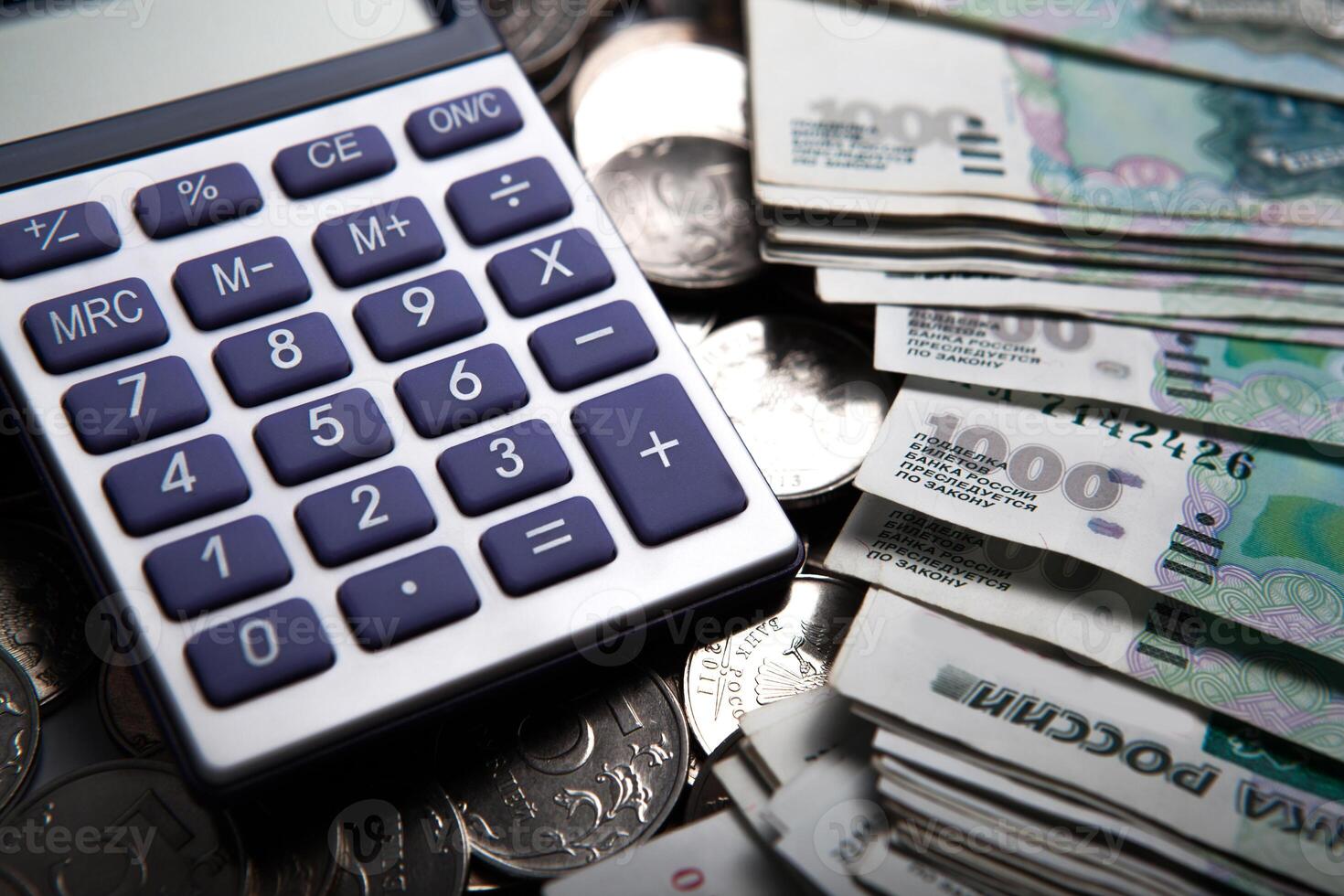 money in the form of banknotes and coins with calculator photo