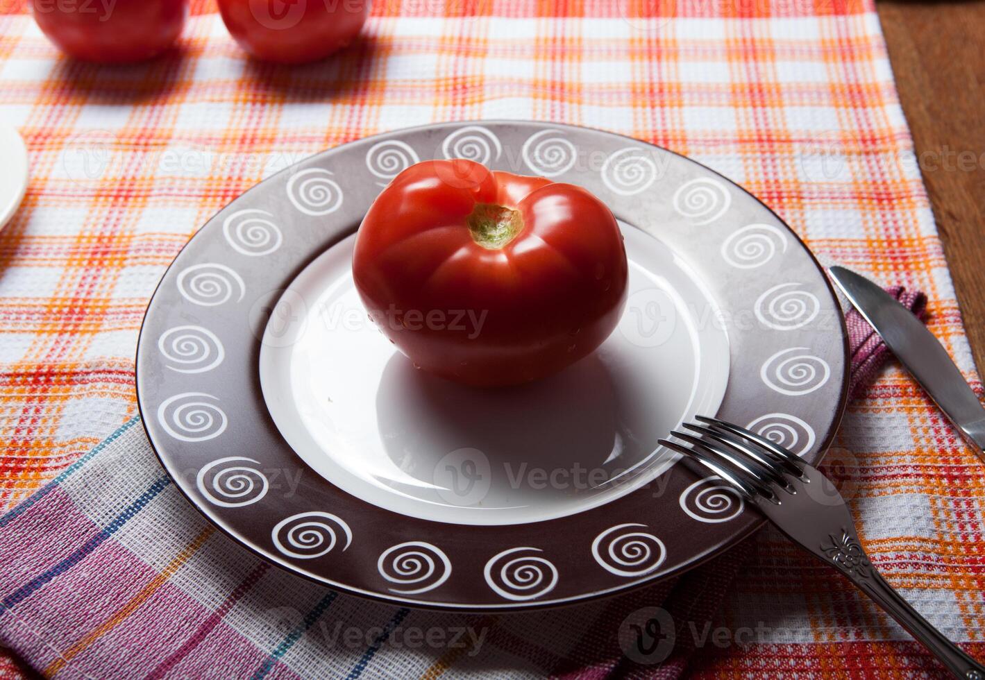 red tomato on a plate photo