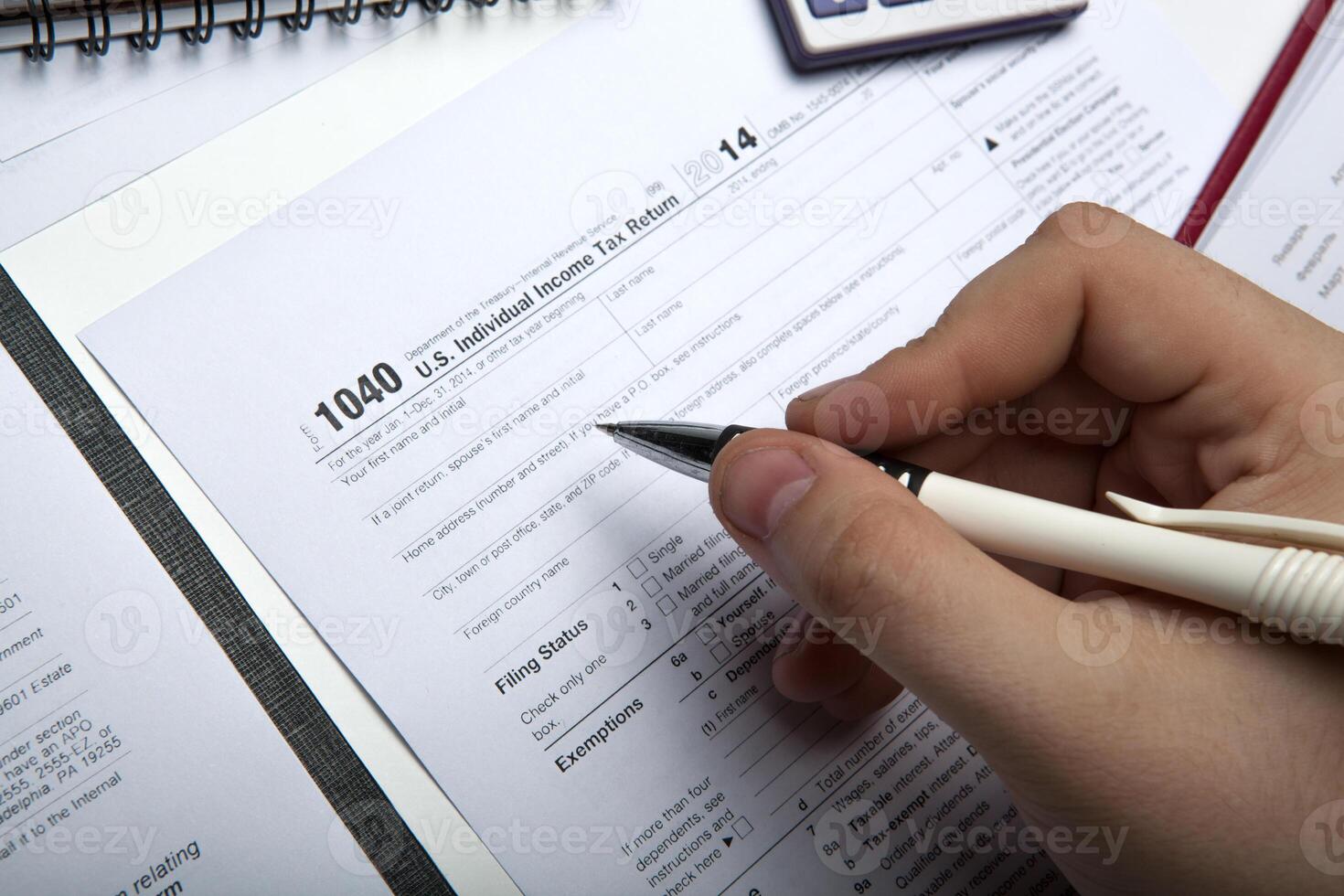 filling tax return on desktop photo