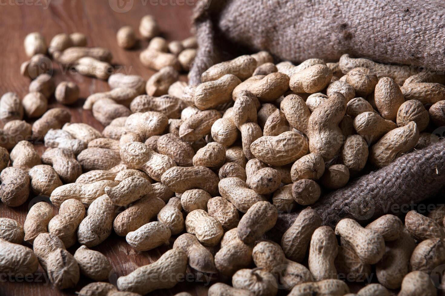 large grains of peanuts in the shell and the bag photo