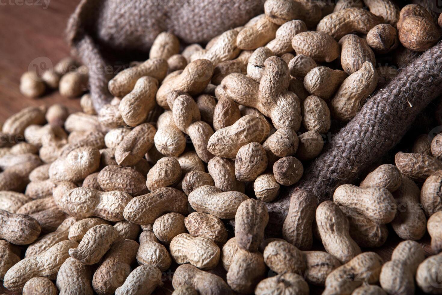 large grains of peanuts in the shell and the bag photo