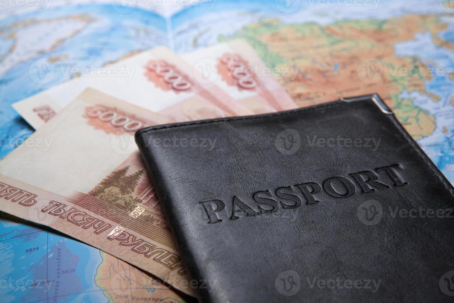 passport in the bag on a map with bank notes photo