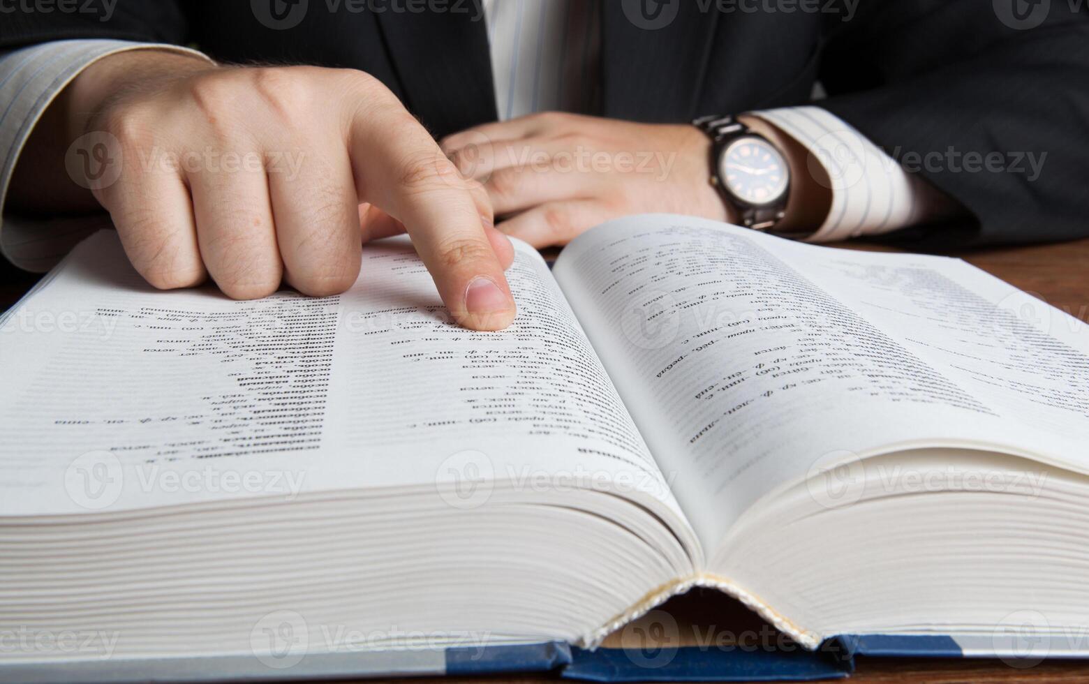 man looking in the large dictionary photo