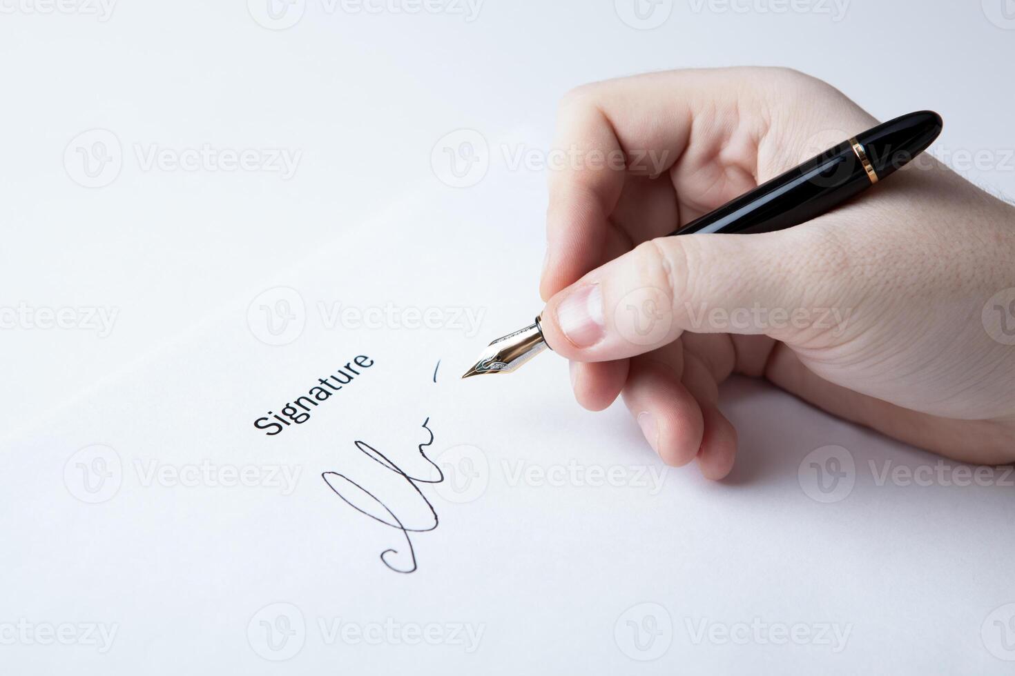 pen in the man's hand and signature photo