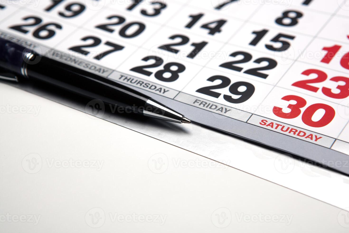 wall calendar with pen closeup photo