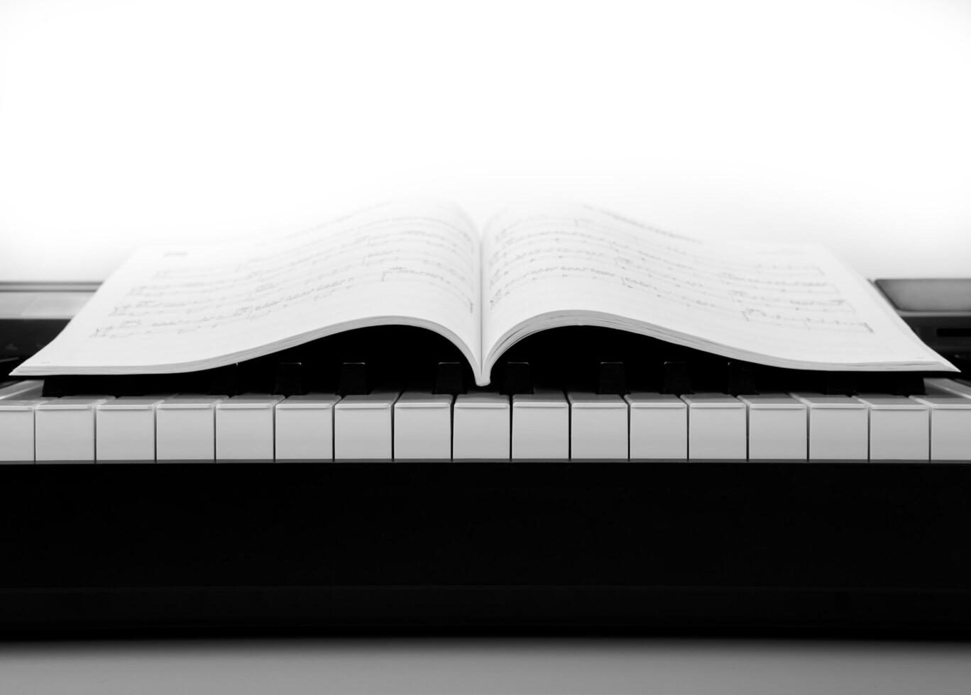 Piano keys and musical book photo