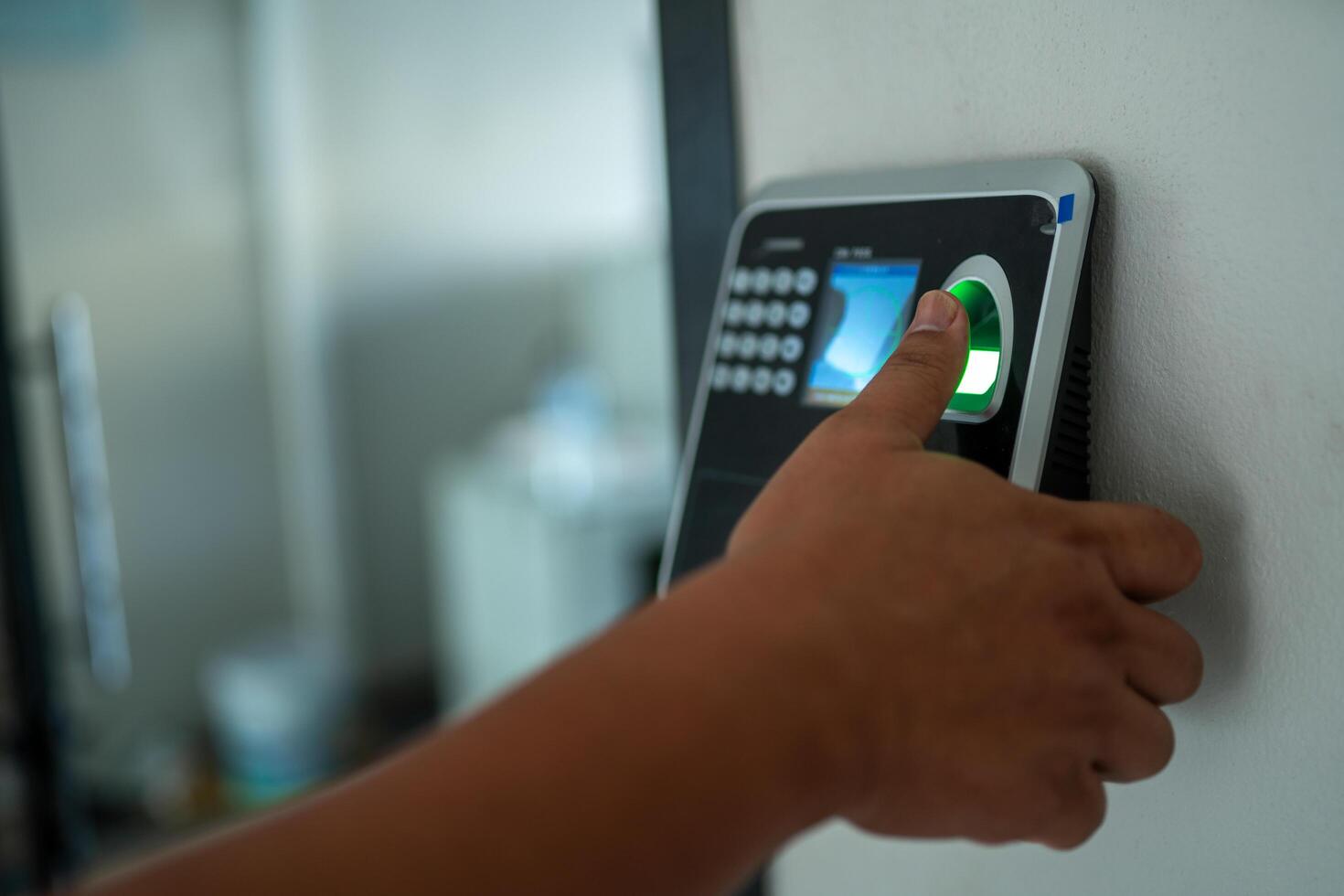 A person is using a green electronic device to scan their finger photo