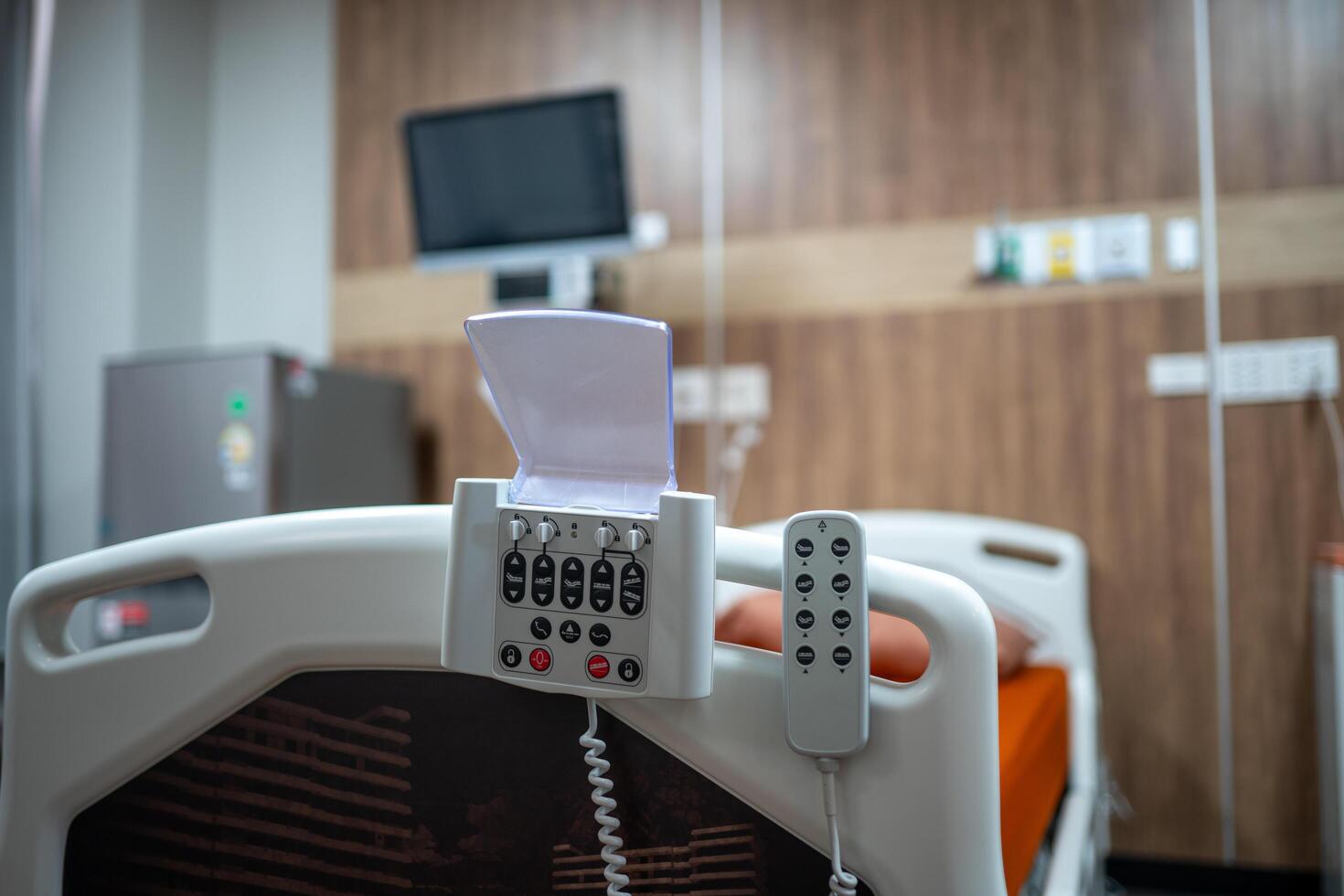A hospital bed with a remote control on it photo