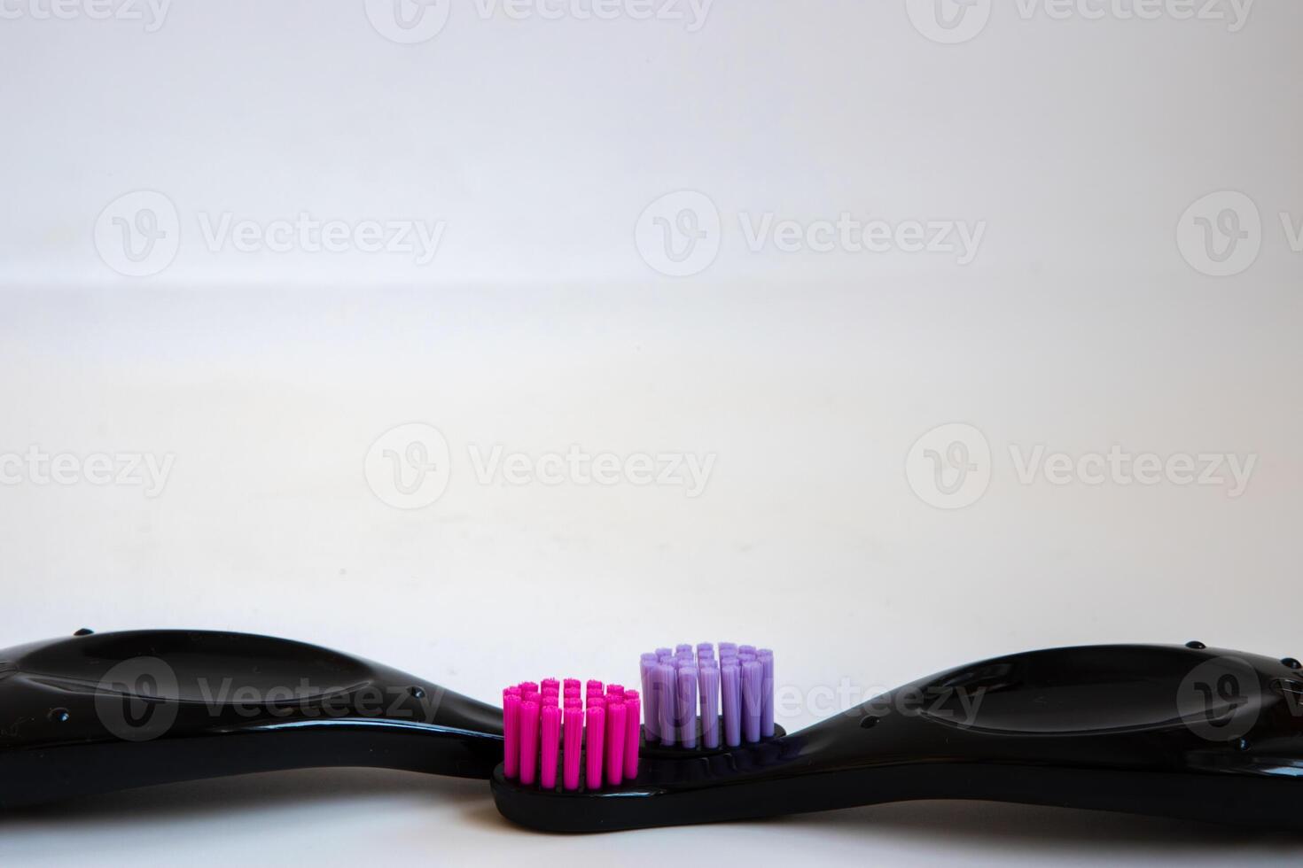 Close up toothbrush neon pink color with toothpaste on blue background. Dentists day concept. Toothbrush day. Copy space photo