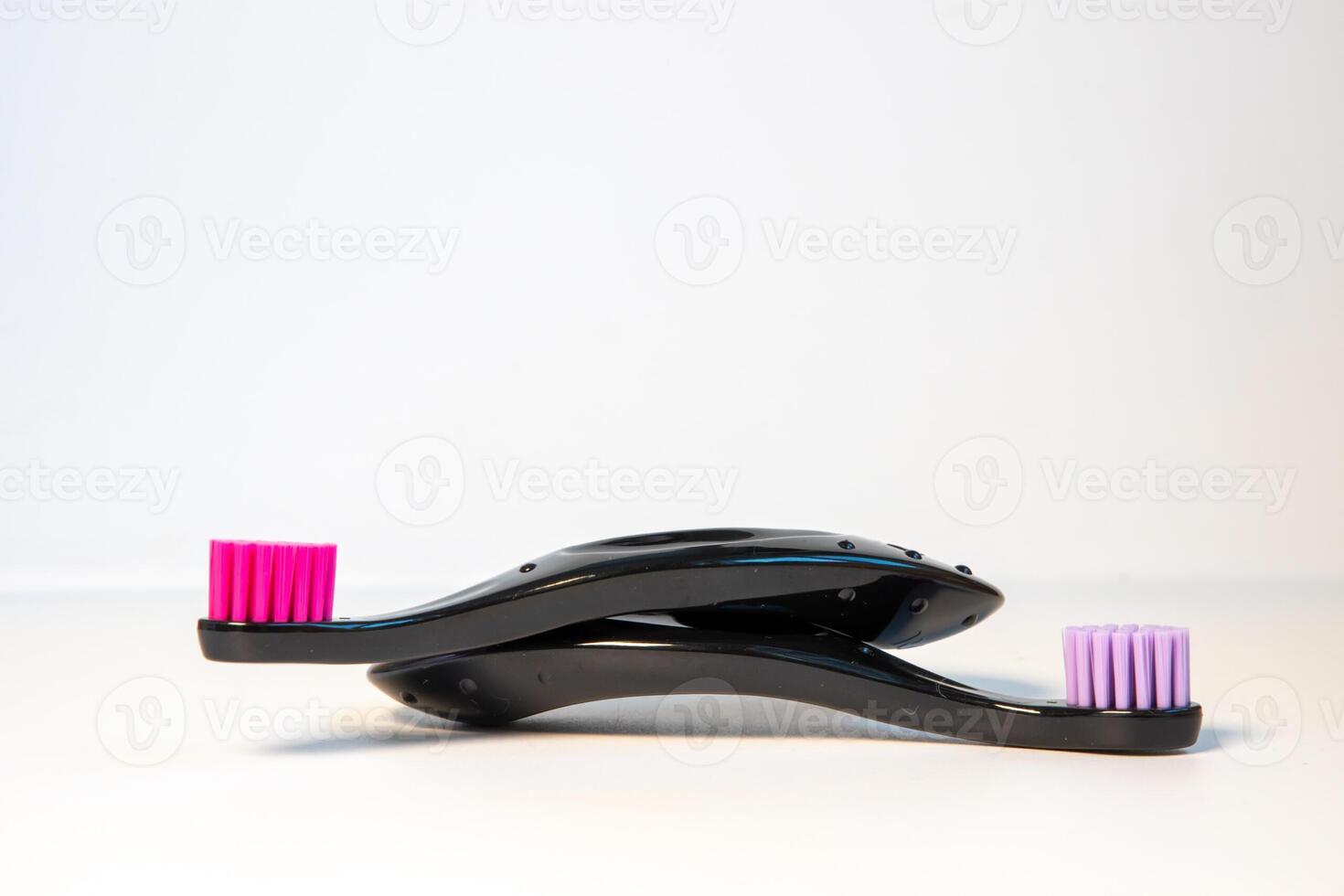 Close up toothbrush neon pink color with toothpaste on blue background. Dentists day concept. Toothbrush day. Copy space photo