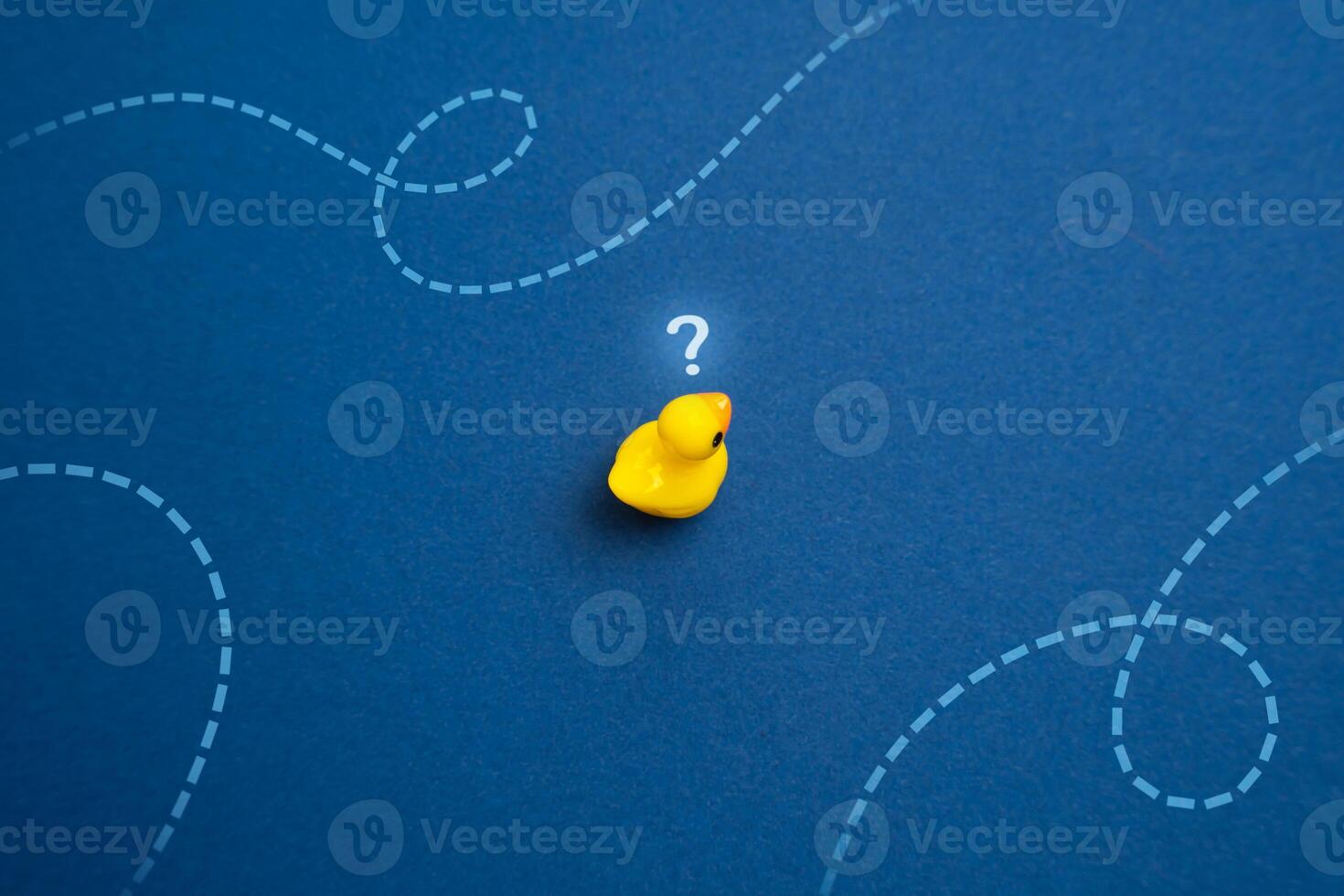 Yellow duck thinks where to swim. Concept of navigation and making plans for the future. Find your purpose in life and when choosing a profession. Search for new ideas and goals. photo