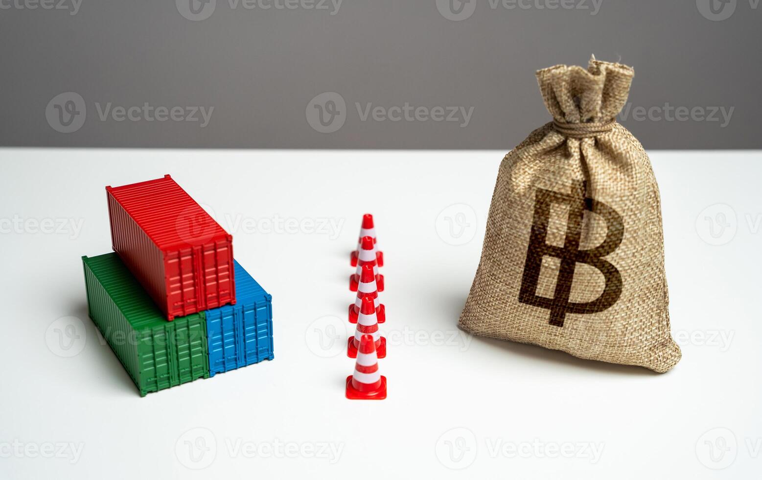 Shipping containers with goods and thai baht money bag are separated by a barrier. Naval blockade. Logistics difficulties. Economic sanctions. Break a trade deal. photo