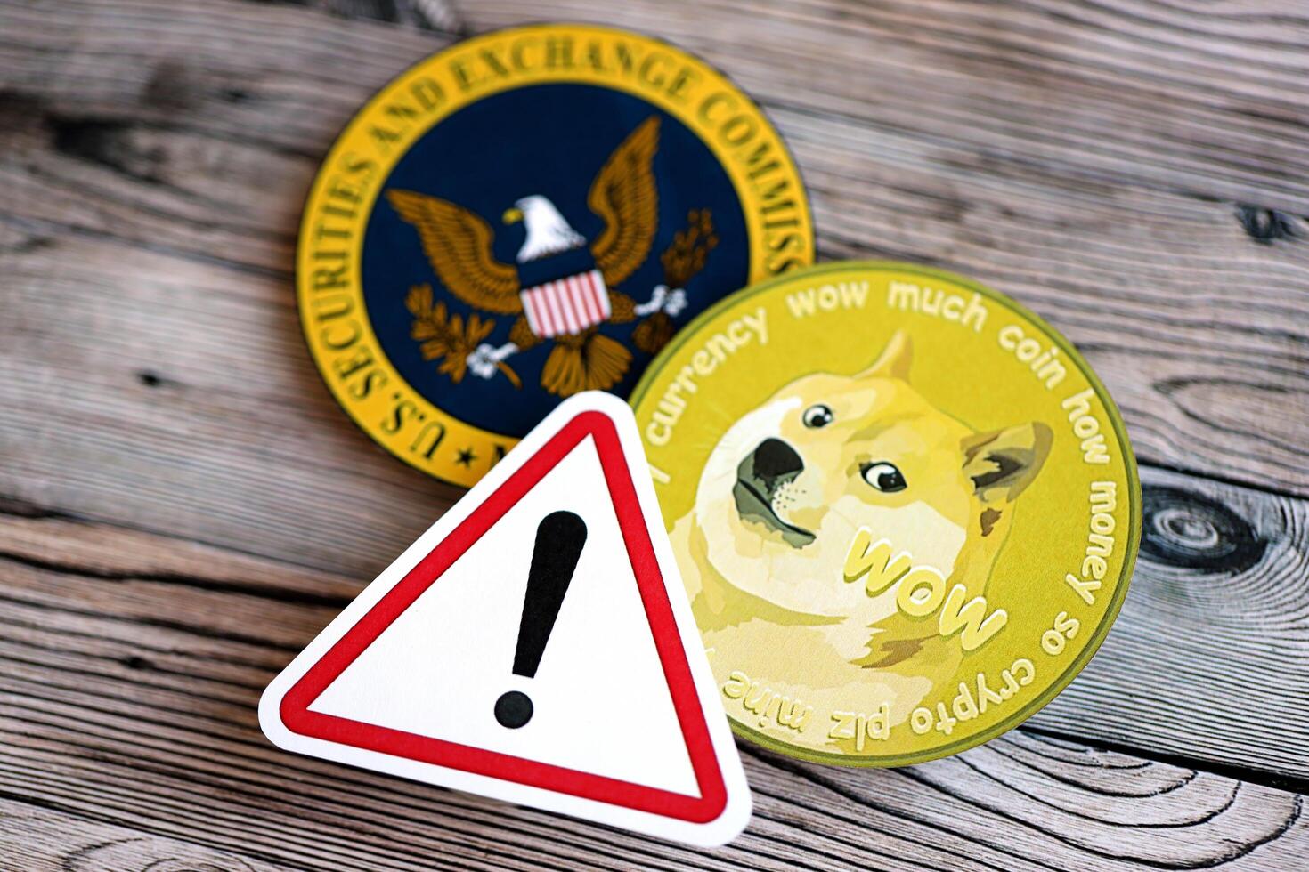 KYIV, UKRAINE - AUGUST 17, 2024 DOGE Meme coin and red paper attention sign with Securities and Exchange Commission on wooden background photo