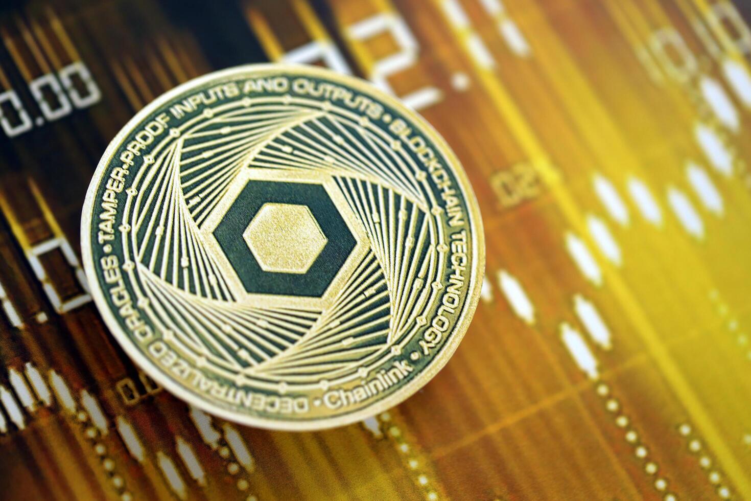 KYIV, UKRAINE - AUGUST 17, 2024 Chainlink LINK coin on dark cryptocurrency digital trading chart in golden yellow colors photo