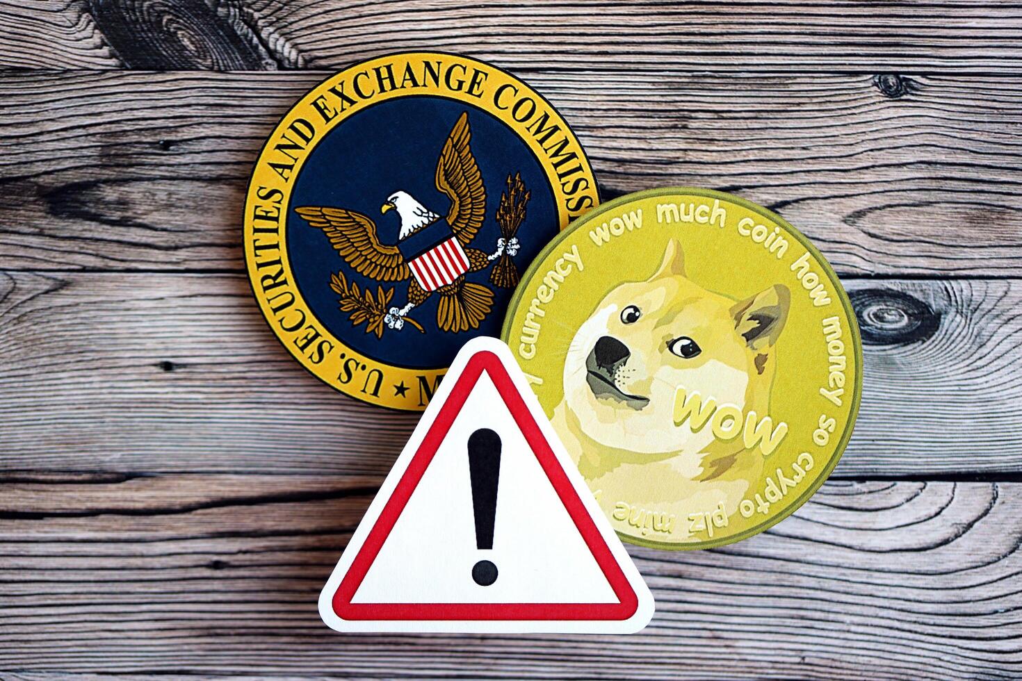KYIV, UKRAINE - AUGUST 17, 2024 DOGE Meme coin and red paper attention sign with Securities and Exchange Commission on wooden background photo