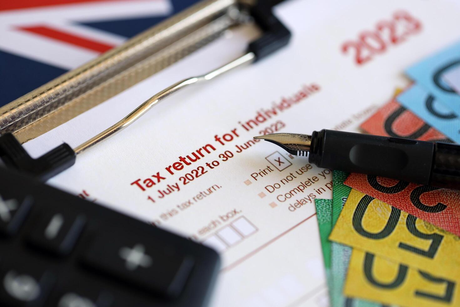 KYIV, UKRAINE - JULY 10, 2024 Australian Tax Return for individuals blank form lies on table of Australian Government taxation office photo