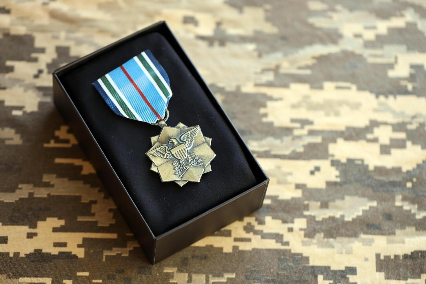 KYIV, UKRAINE - JULY 10, 2024 US Joint Service Achievement medal. United States military award medal with ribbon and pin. Handmade paper theater props photo