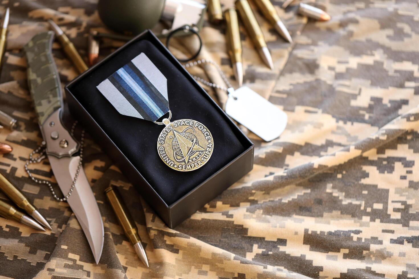 KYIV, UKRAINE - JULY 10, 2024 US Space Force Good Conduct medal. United States military award medal with ribbon and pin. Handmade paper theater props photo