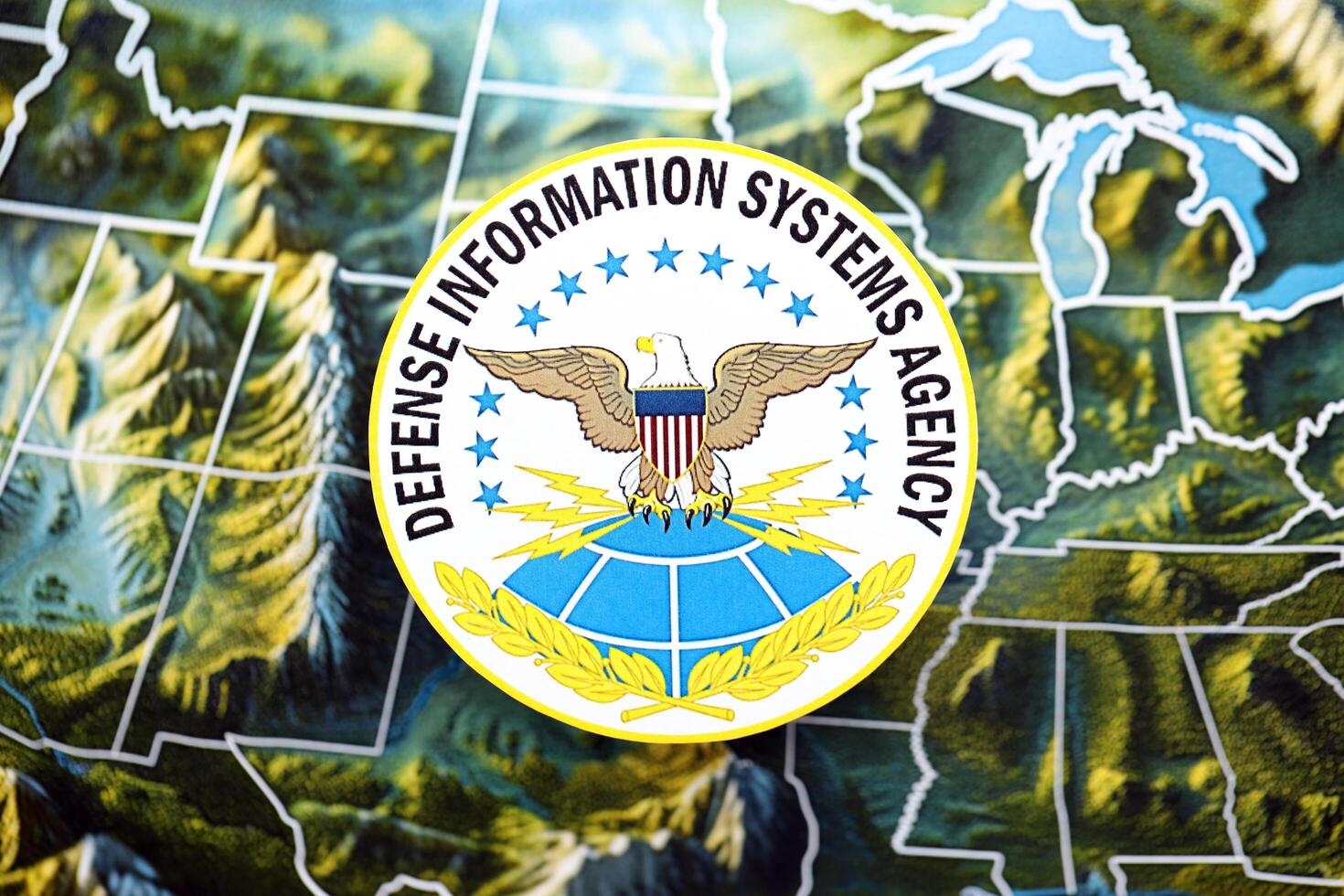 KYIV, UKRAINE - JUNE 26, 2024 Defense Information Systems Agency coat of arms on paper map of United States photo