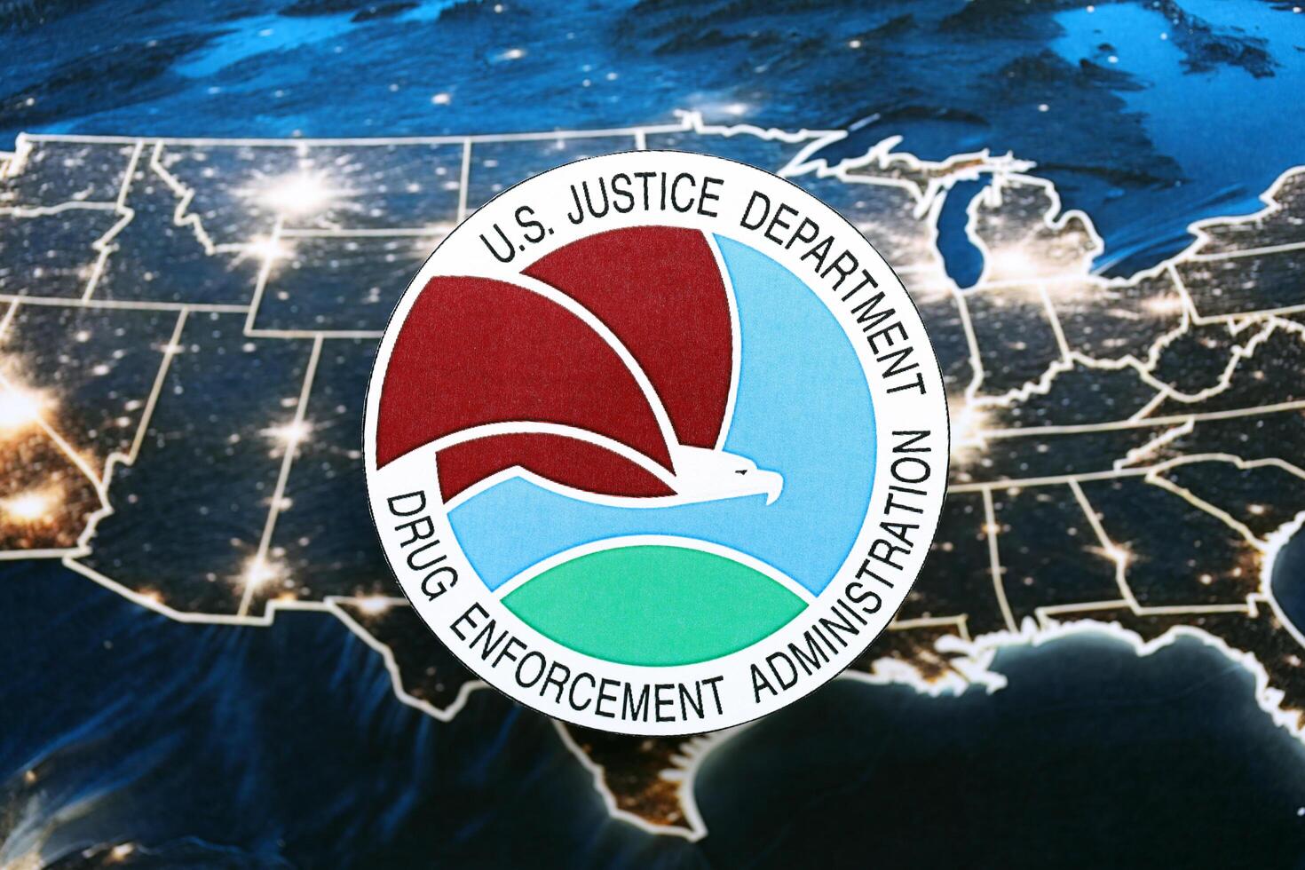 KYIV, UKRAINE - JUNE 26, 2024 U.S. Justice Department Drug Enforcement Administration coat of arms on paper map of United States photo