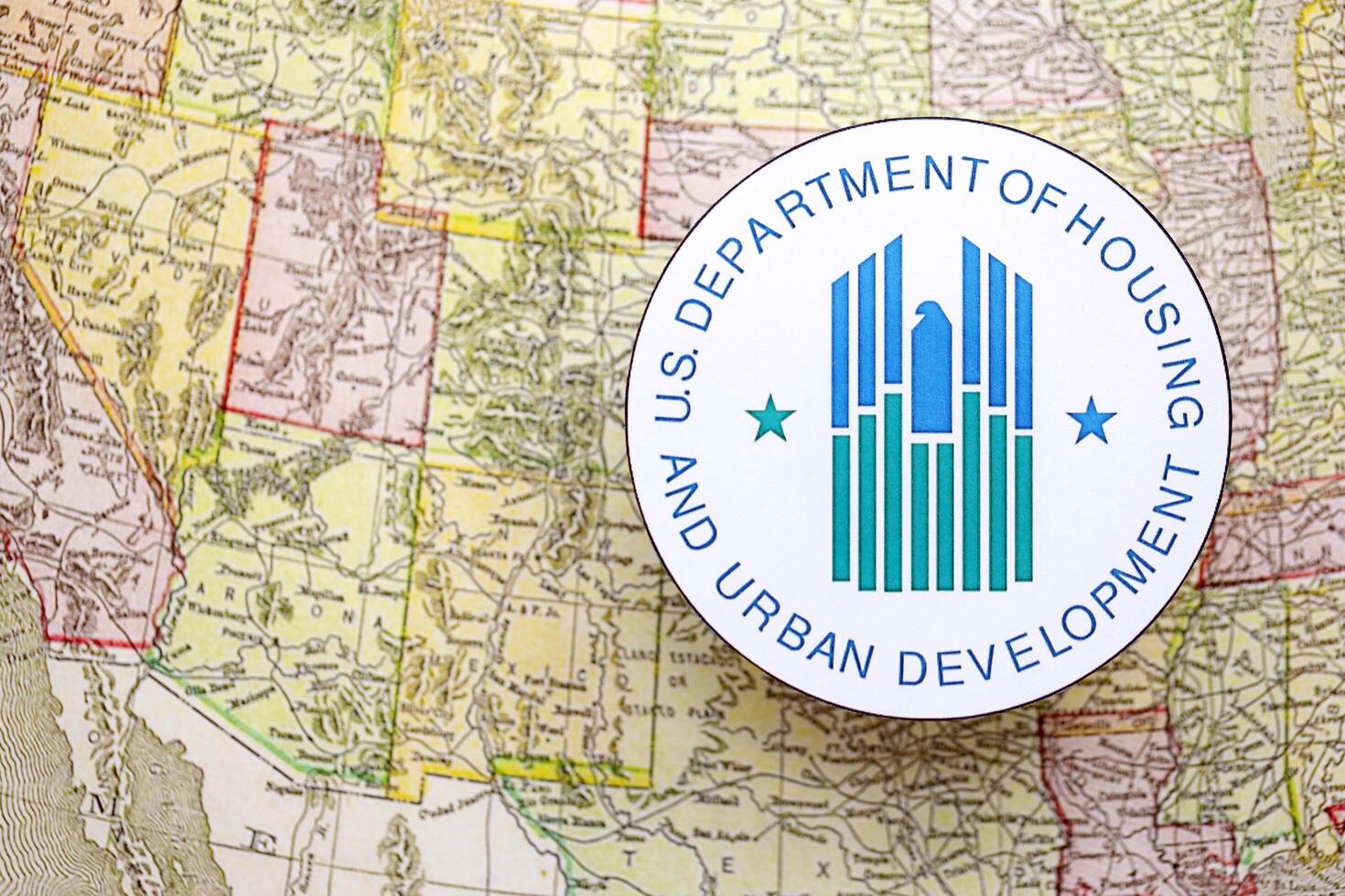 KYIV, UKRAINE - JUNE 26, 2024 U.S. Department of Housing and Urban Development coat of arms on paper map of United States photo