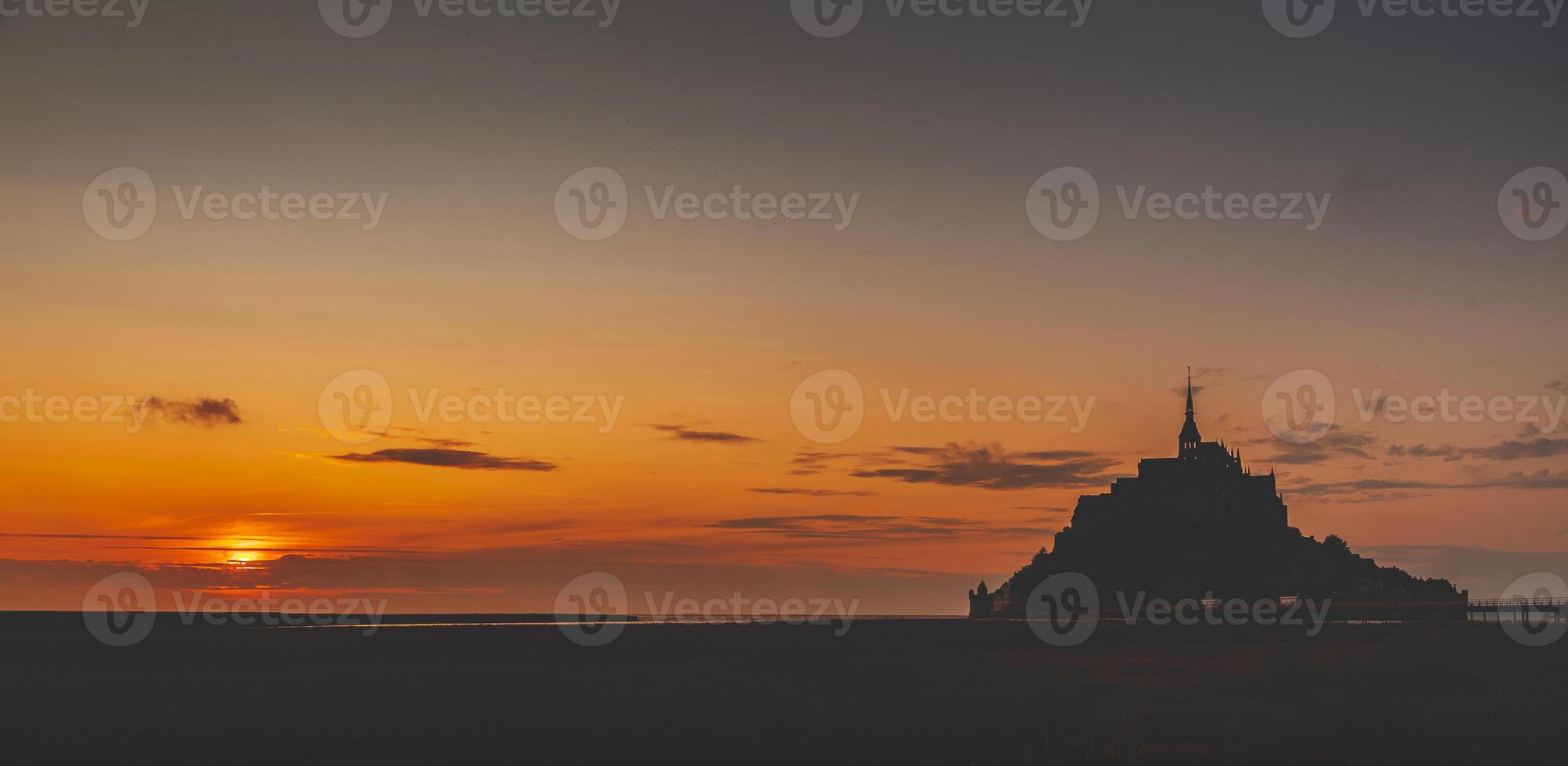 Panoramic view of the famous abbey of Le Mont Saint-Michel at sunset, Normandy, France photo
