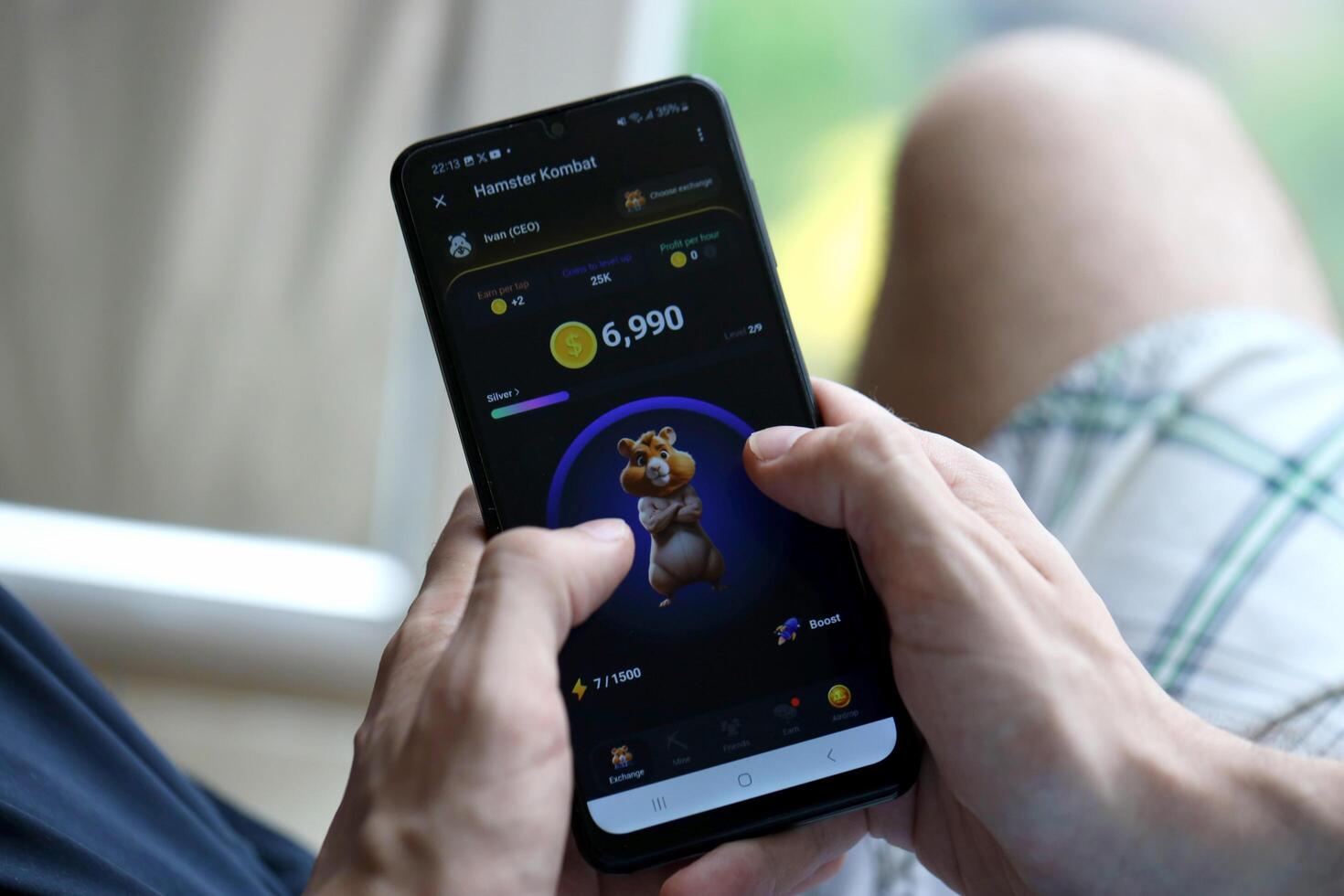 KYIV, UKRAINE - APRIL 20, 2024 Hamster Kombat telegram bot on smartphone screen. Hamster Kombat is a viral Telegram crypto game for earn HMSTR tokens by managing virtual crypto exchange photo