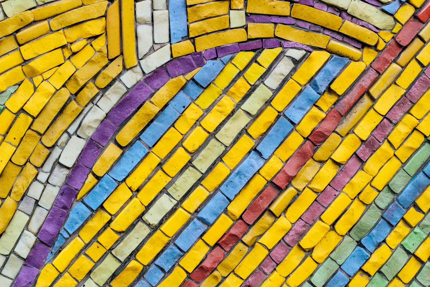 texture of multi-colored stones. Background from vintage mosaic on the wall. photo