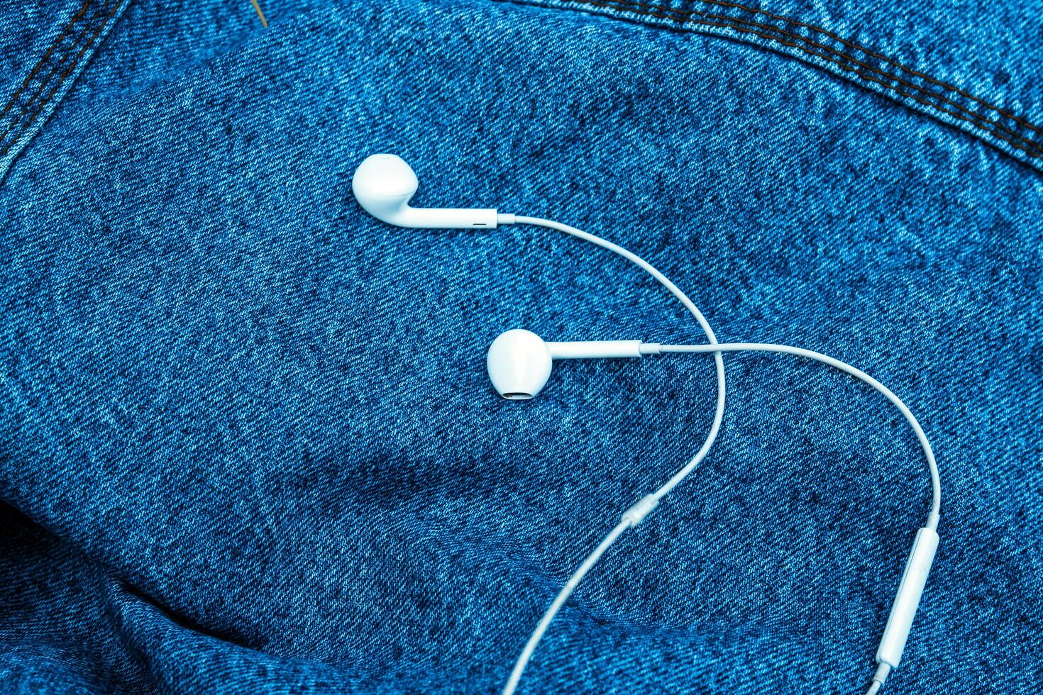 heart shaped headphones on jeans background photo