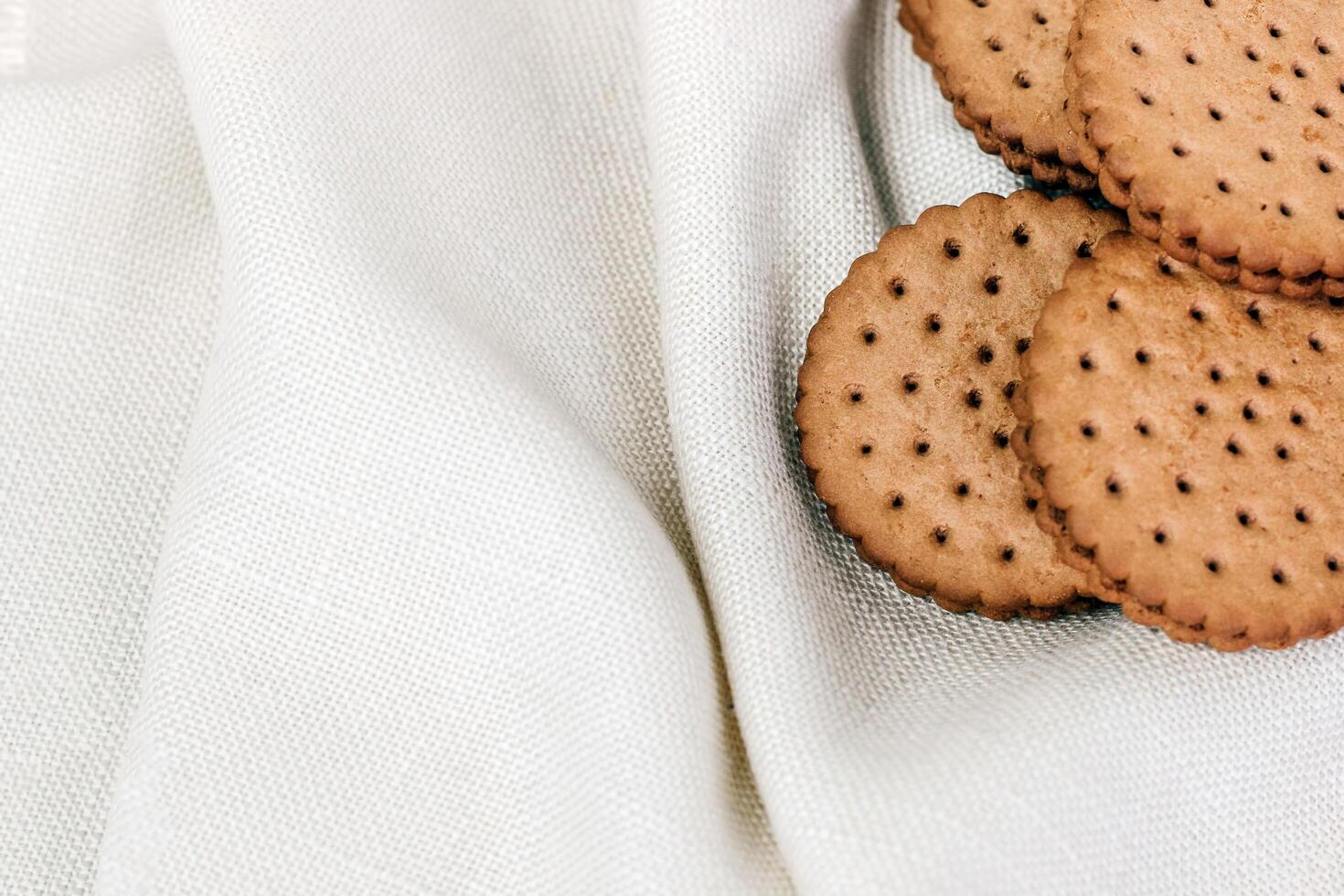 Crispy chocolate cinnamon with holes on a wooden board. Round biscuits with filling. space for text photo