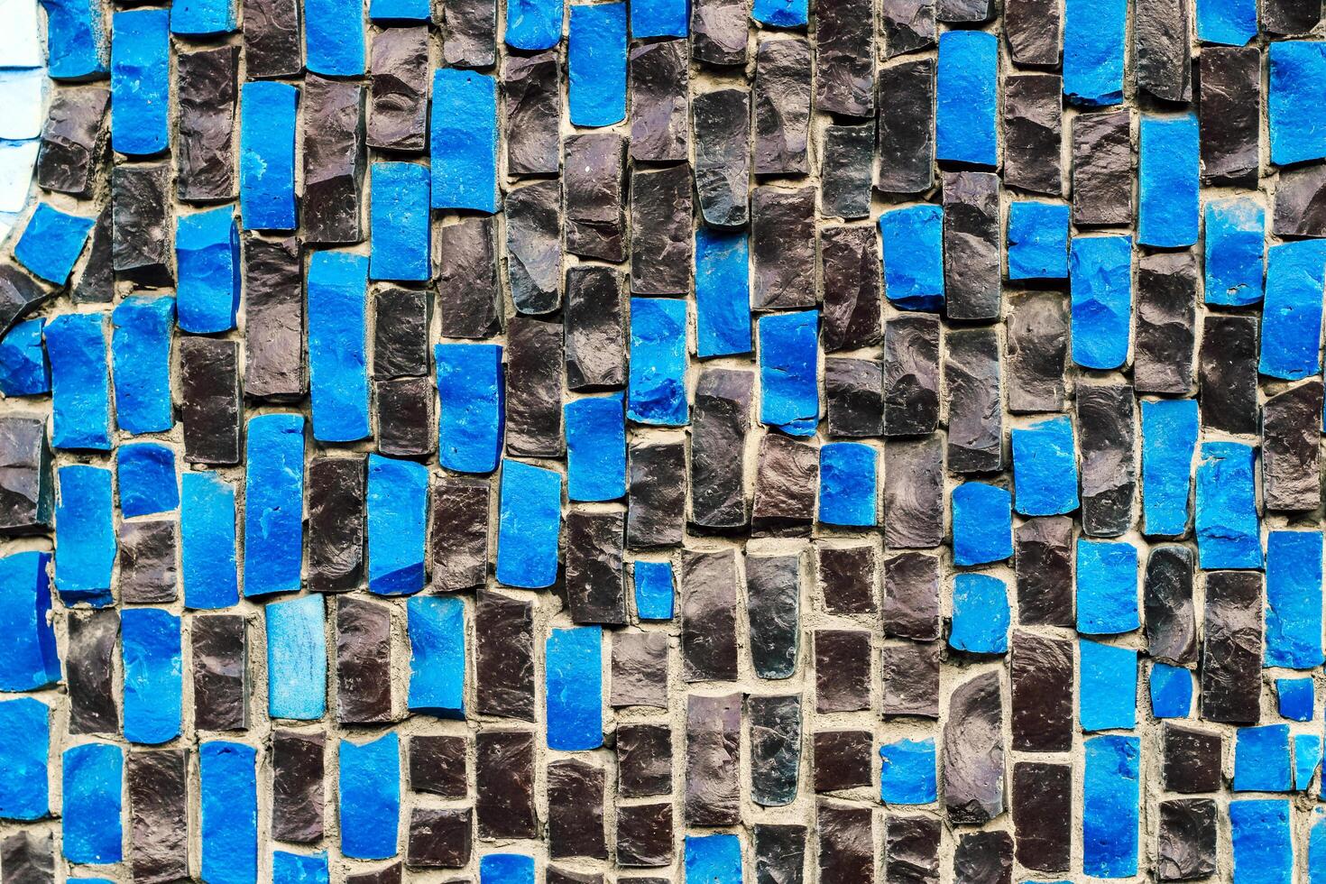 texture of multi-colored stones. Background from vintage mosaic on the wall. photo