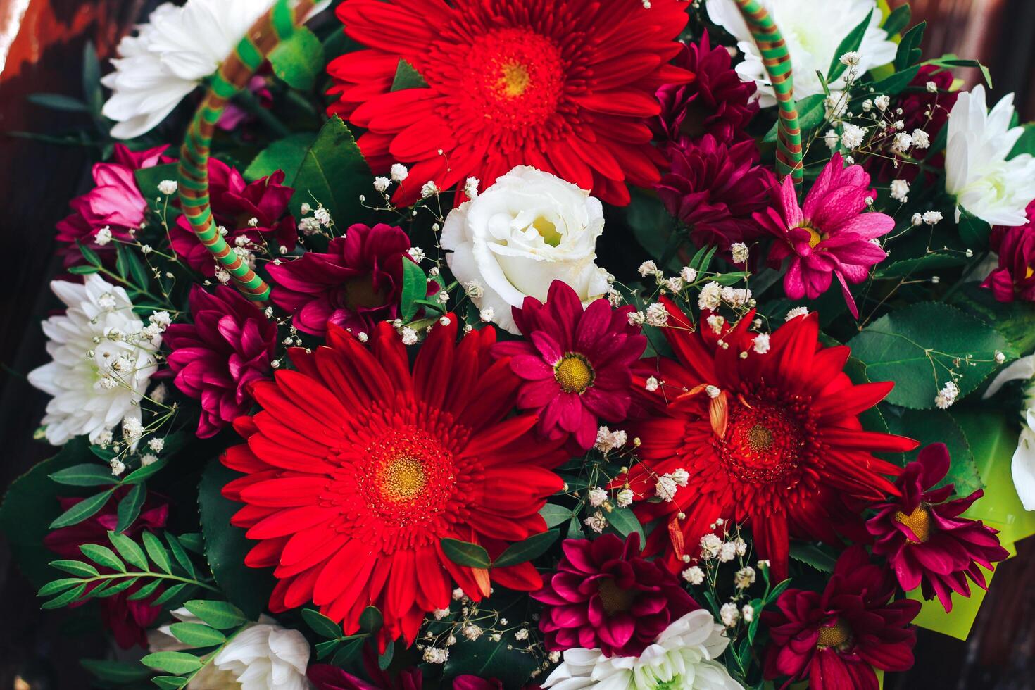 a bouquet of flowers in red colors. gerbera, chrysanthemum, eustoma, gypsophila. Close view photo