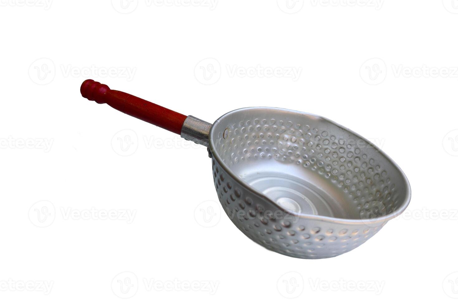A silver pan with a wooden handle sits on a white background. The pan is empty and has a circular shape photo