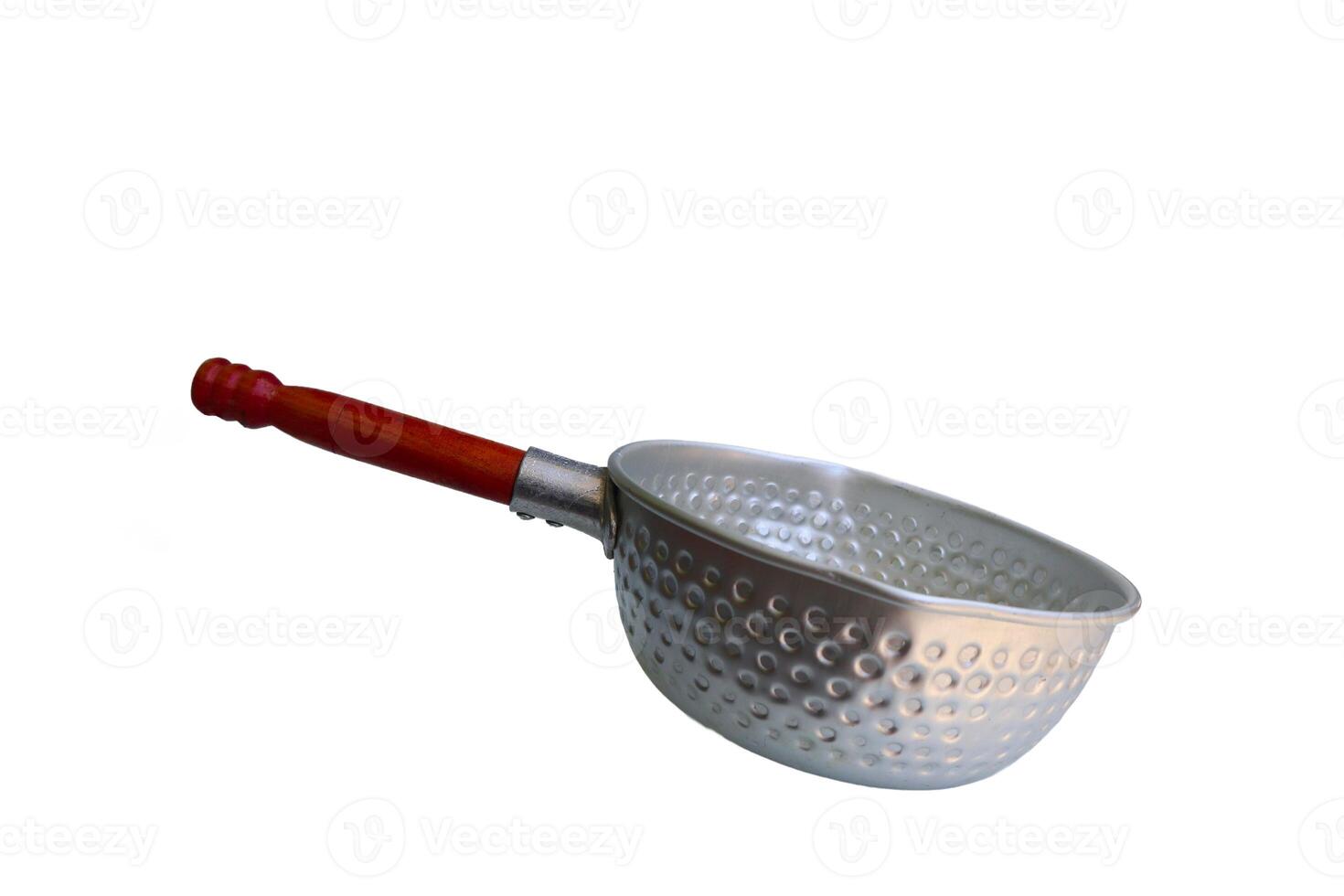 A silver pan with a wooden handle sits on a white background. The pan is empty and has a circular shape photo