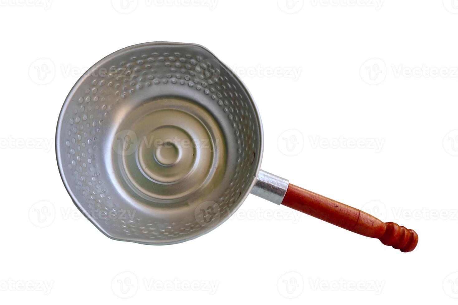 A silver pan with a wooden handle sits on a white background. The pan is empty and has a circular shape photo