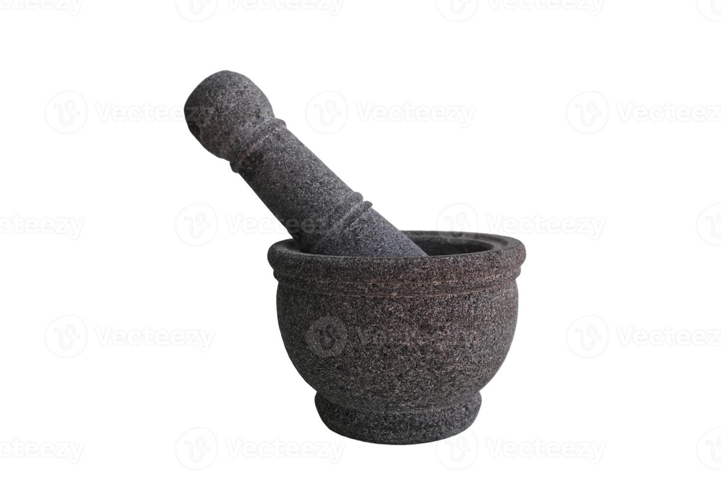 A large mortar and pestle sits on a white background. The mortar is made of stone handle. Concept of tradition and craftsmanship photo