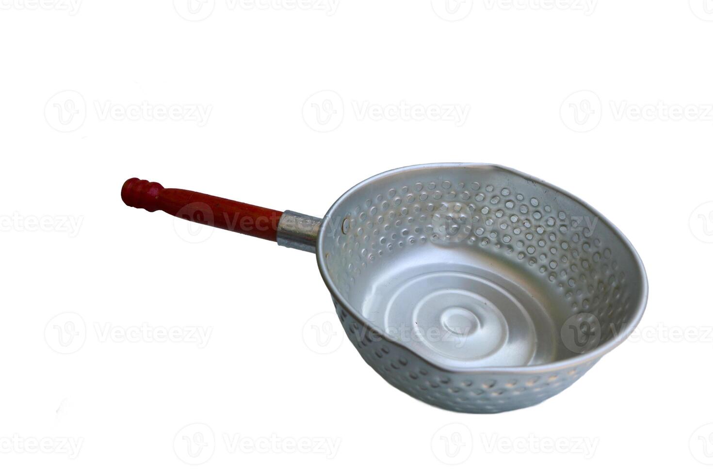 A silver pan with a wooden handle sits on a white background. The pan is empty and has a circular shape photo